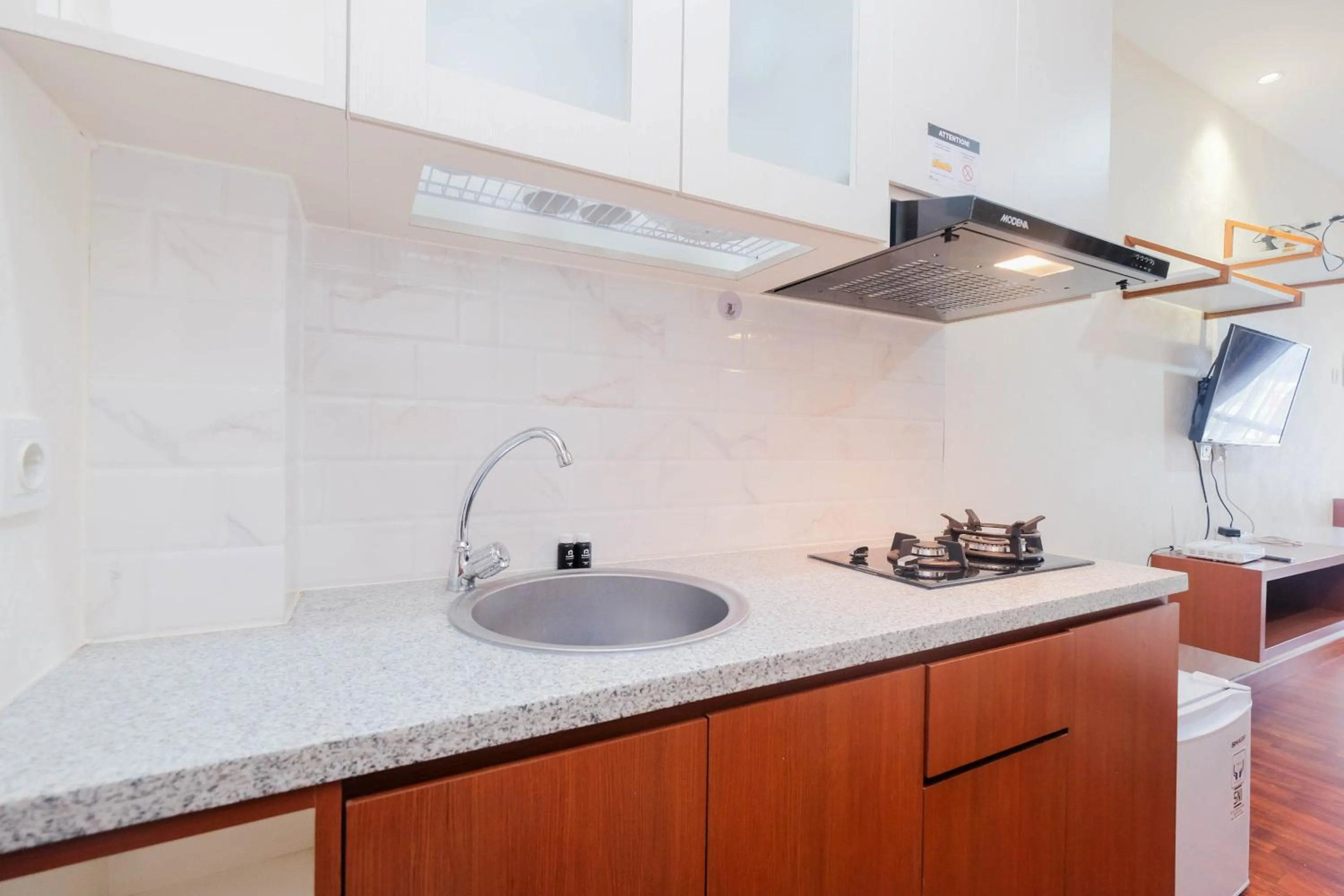 Kitchen or kitchenette in Cozy and Simply Studio Tifolia Apartment near Kelapa Gading By Travelio
