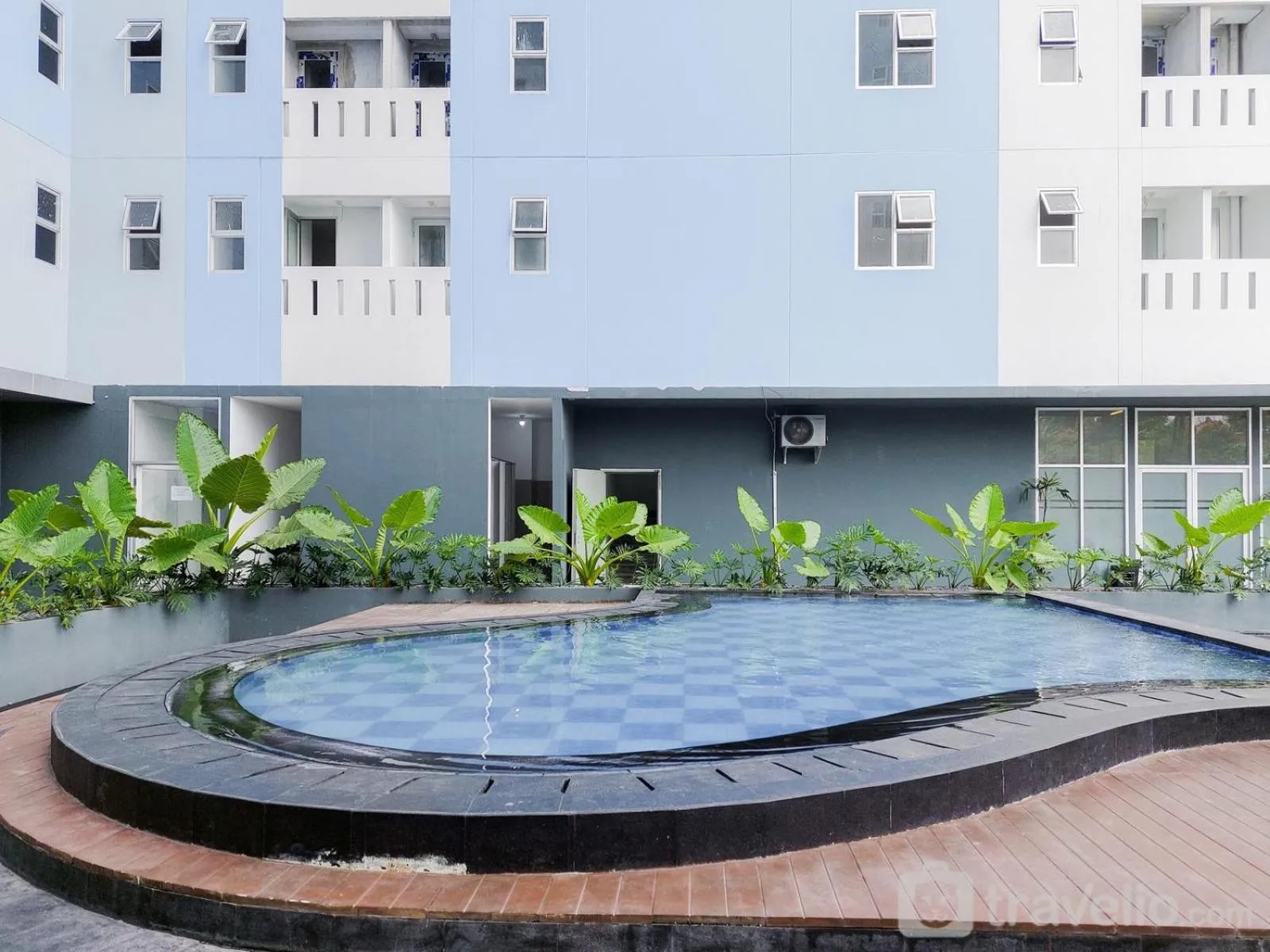 Minimalist Studio Room at Urbantown Serpong Apartment By Travelio