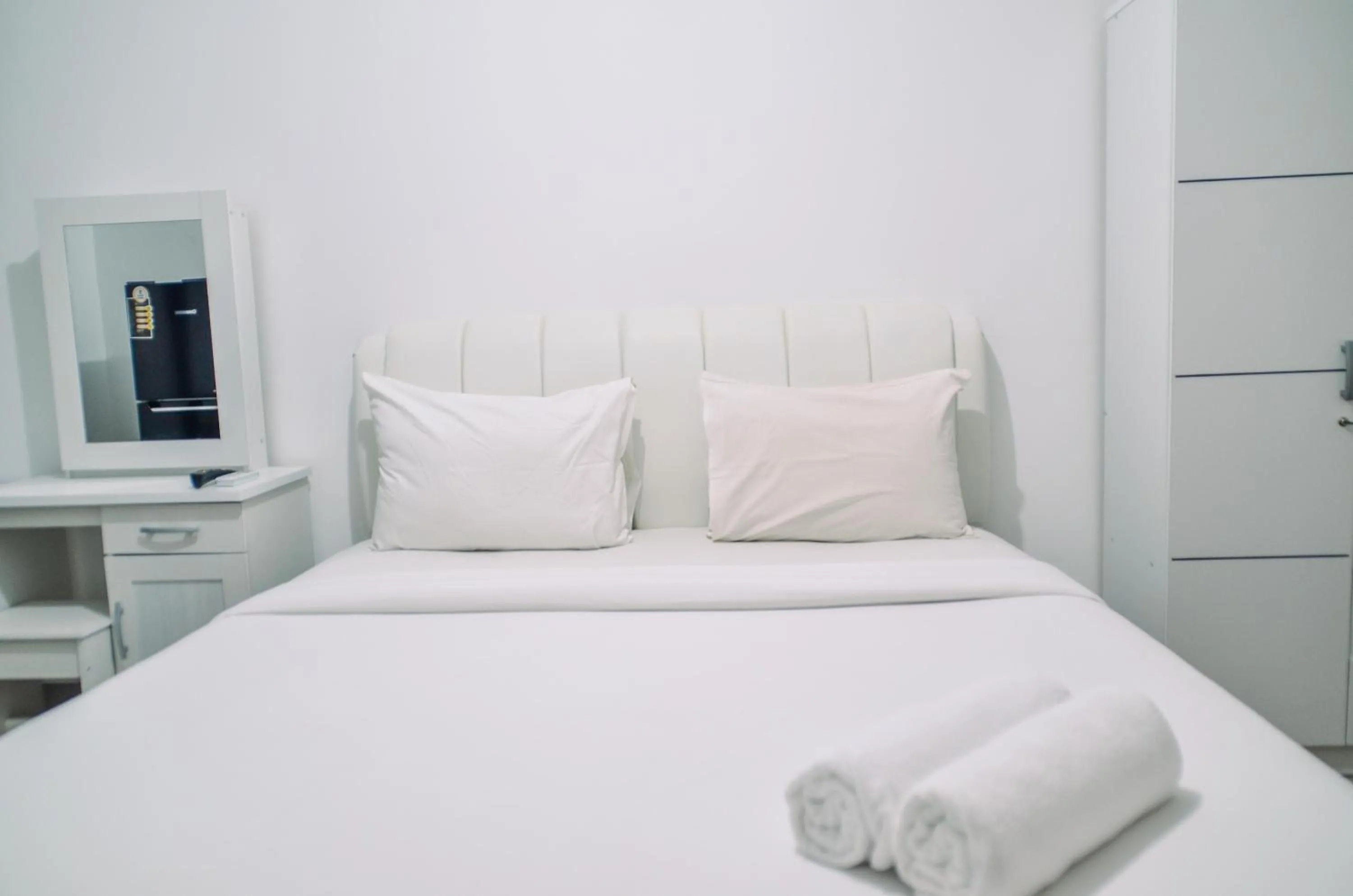 Minimalist Studio Room at Urbantown Serpong Apartment By Travelio