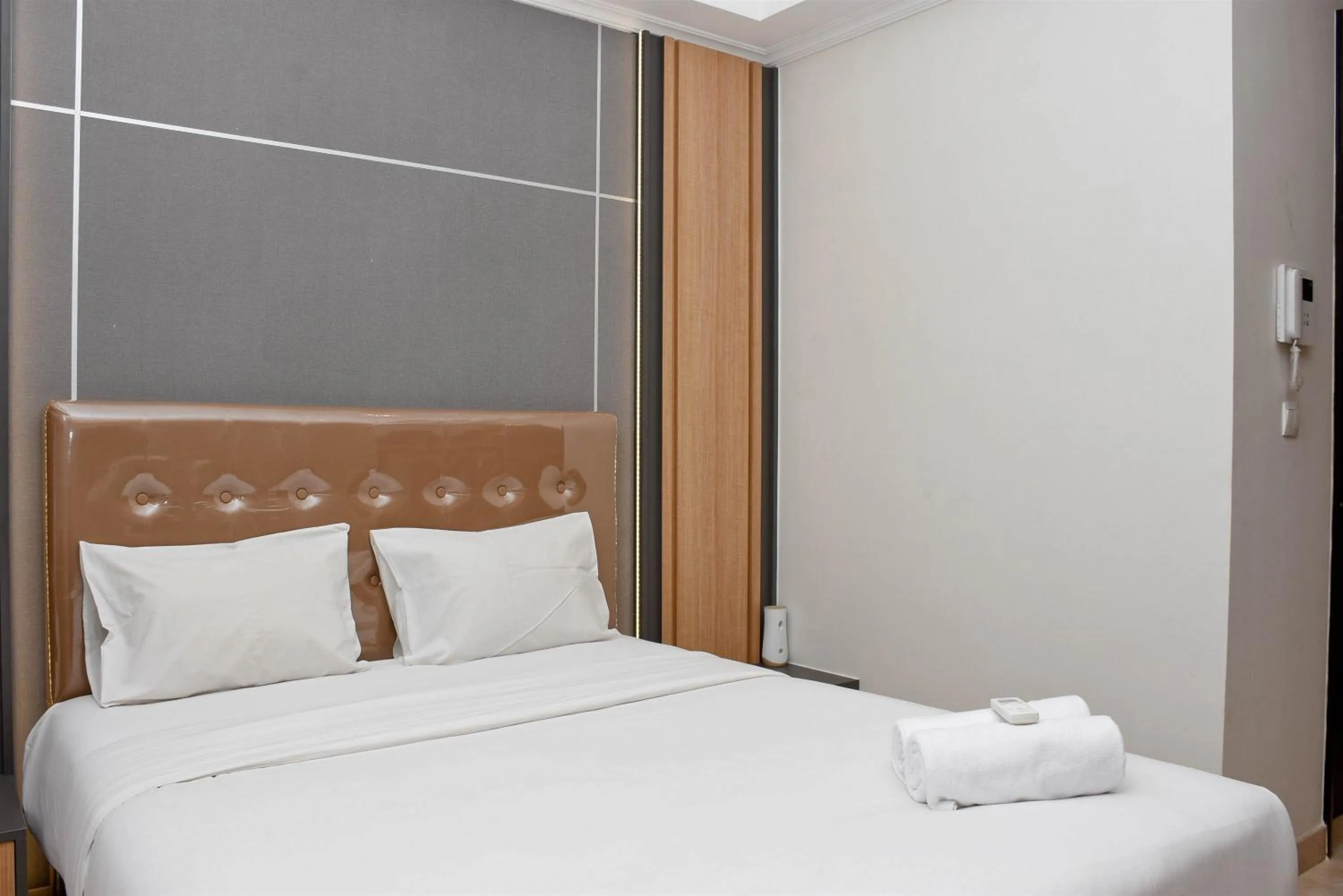 Bed in Cozy Living Studio at Menteng Park Apartment By Travelio