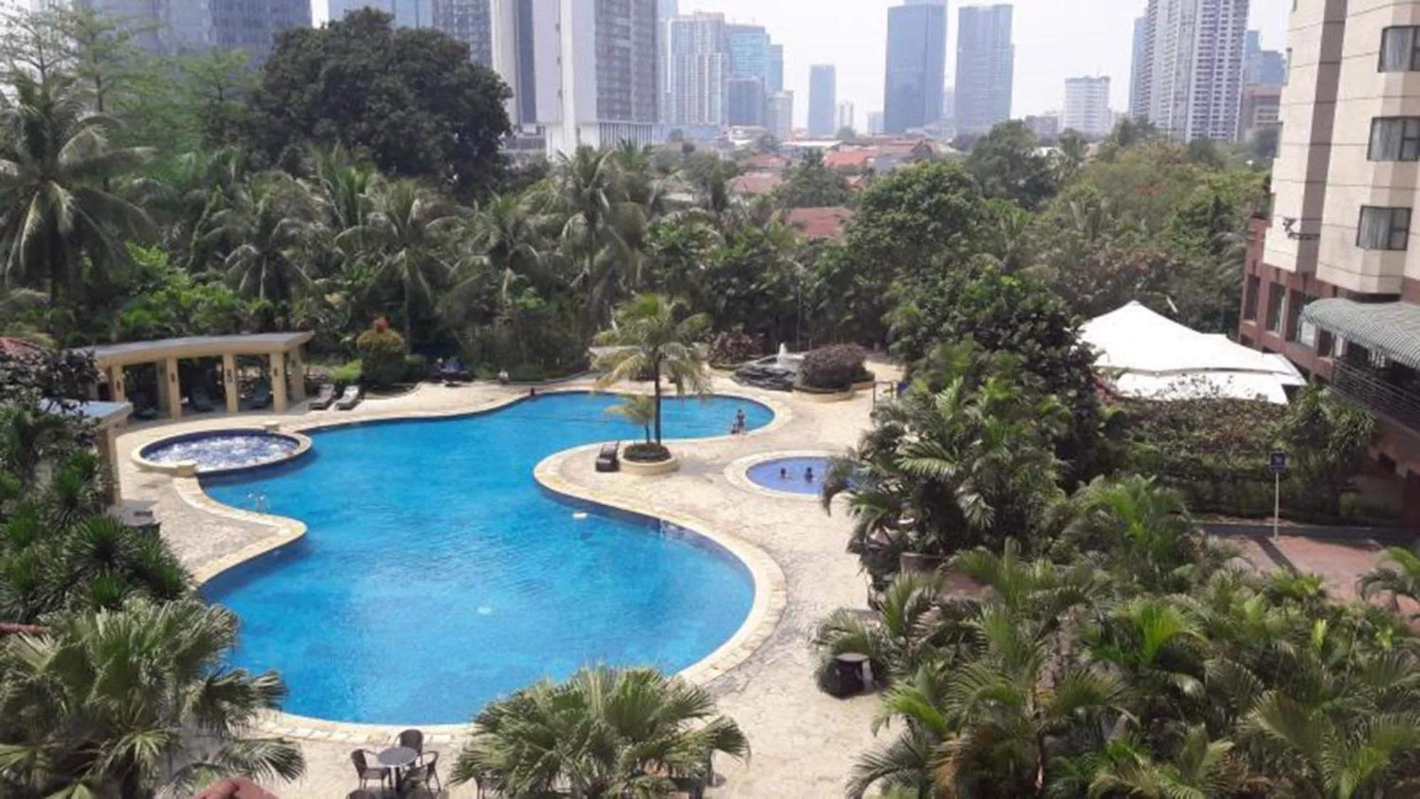 Swimming pool in Comfort 2BR + Extra Room at Sudirman Tower Condominium Apartment By Travelio
