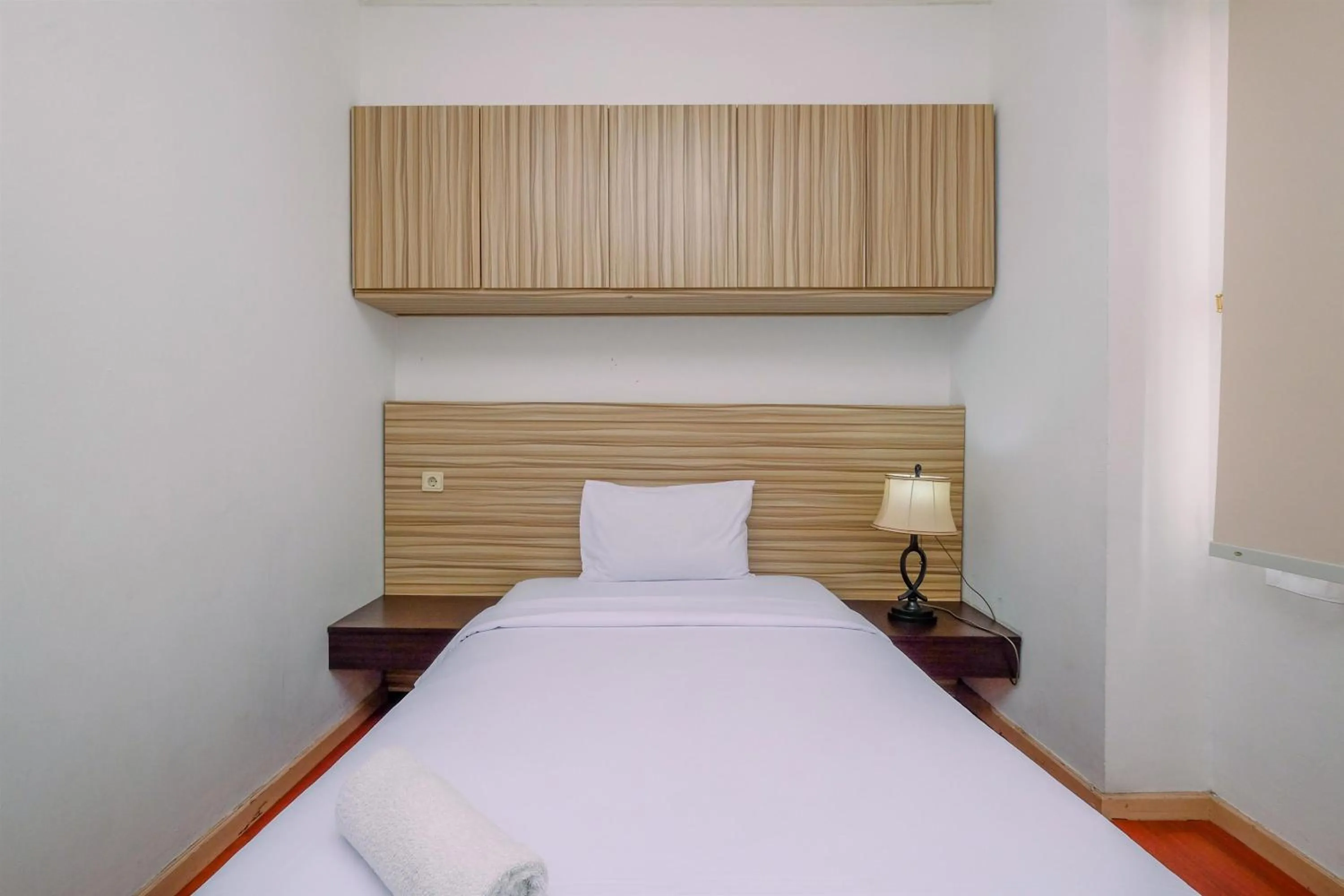 Bed in Comfort 2BR + Extra Room at Sudirman Tower Condominium Apartment By Travelio