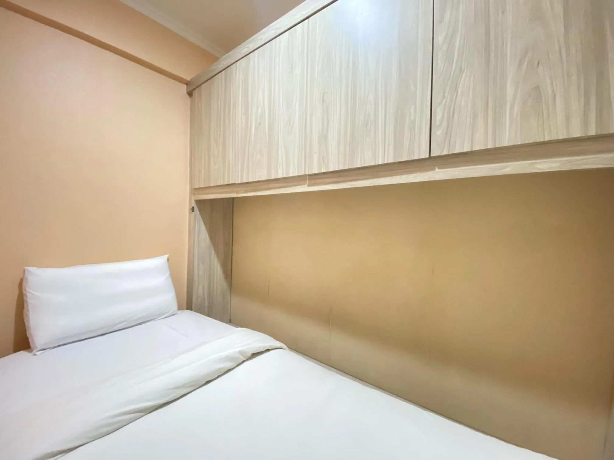 Bed in Cozy Living 2BR Apartment at Jarrdin Cihampelas By Travelio
