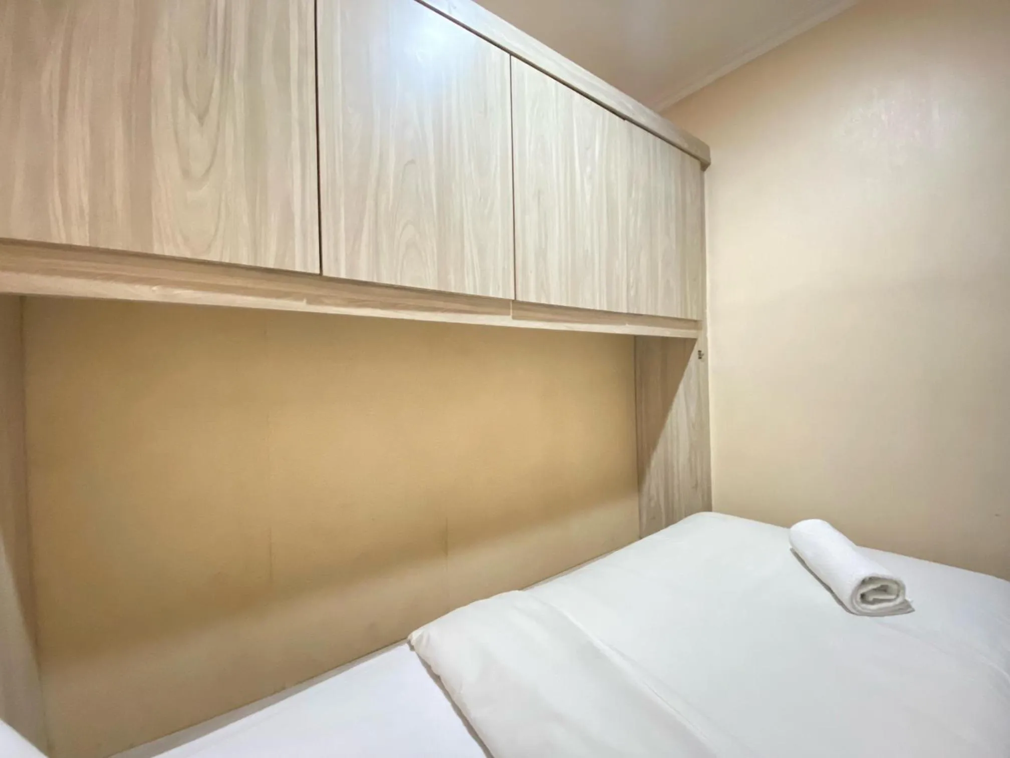 Bed in Cozy Living 2BR Apartment at Jarrdin Cihampelas By Travelio