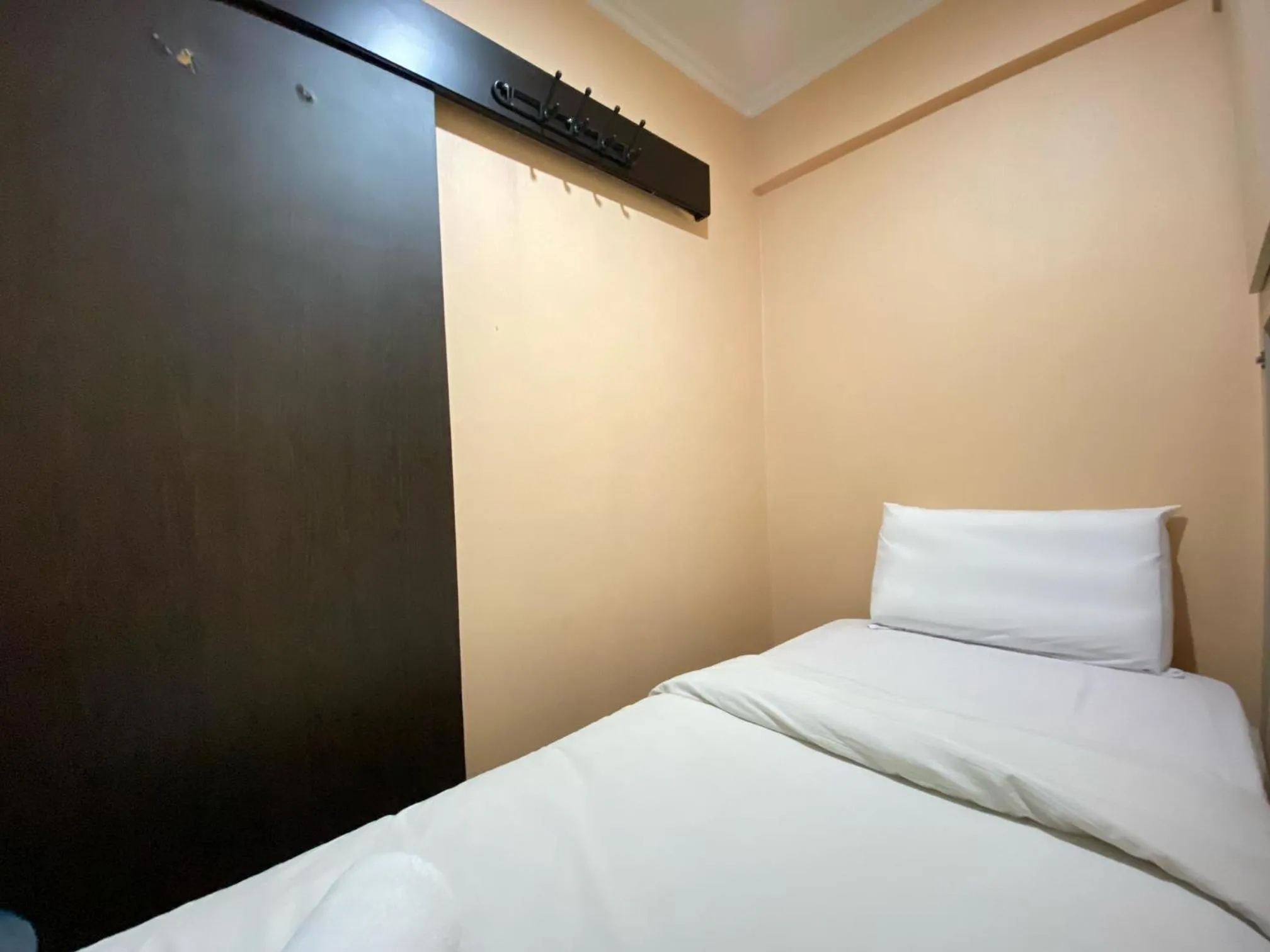 Bed in Cozy Living 2BR Apartment at Jarrdin Cihampelas By Travelio