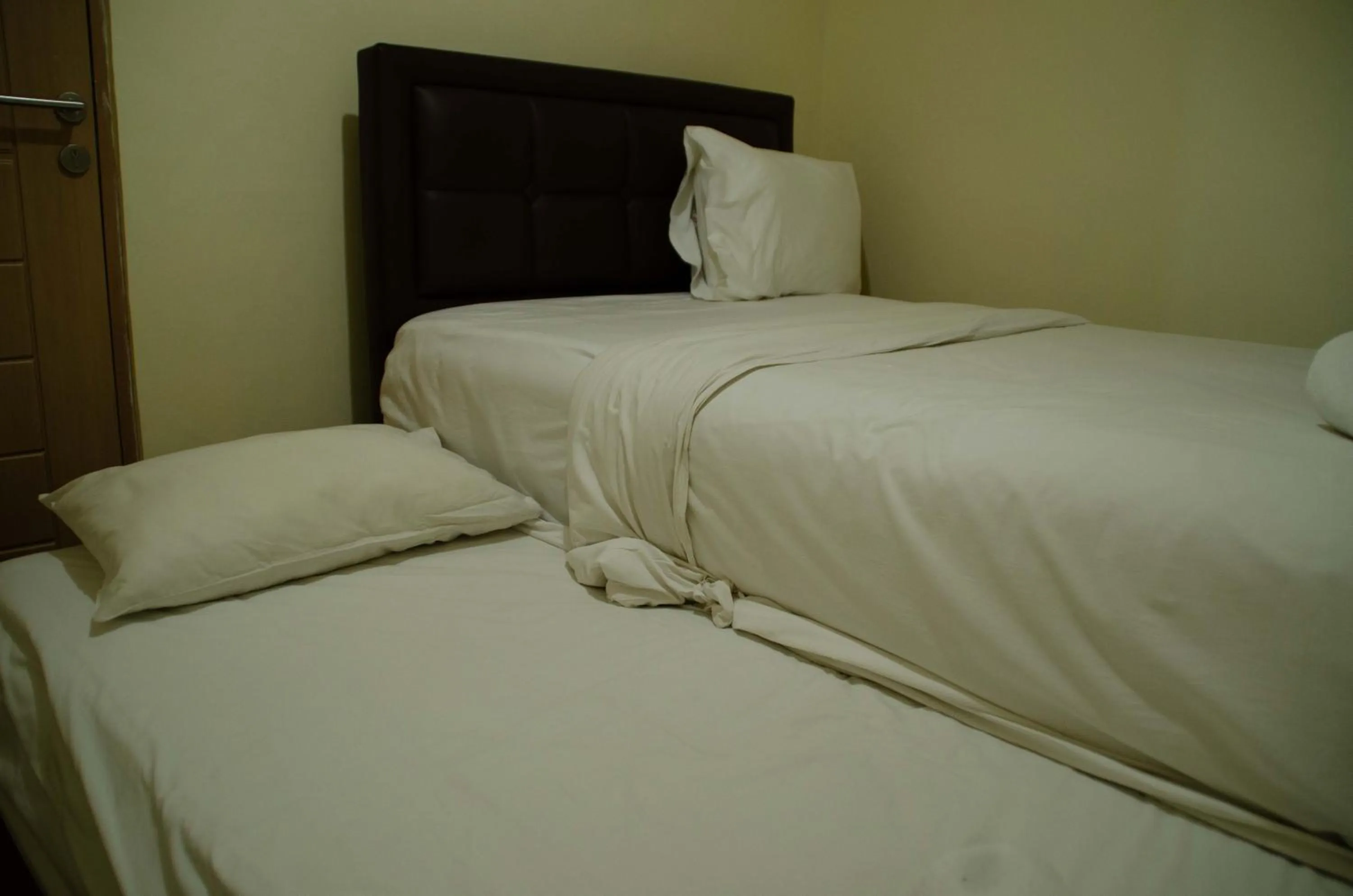 Bed in Spacious and Homey 3BR at Kondominium Rajawali Apartment By Travelio