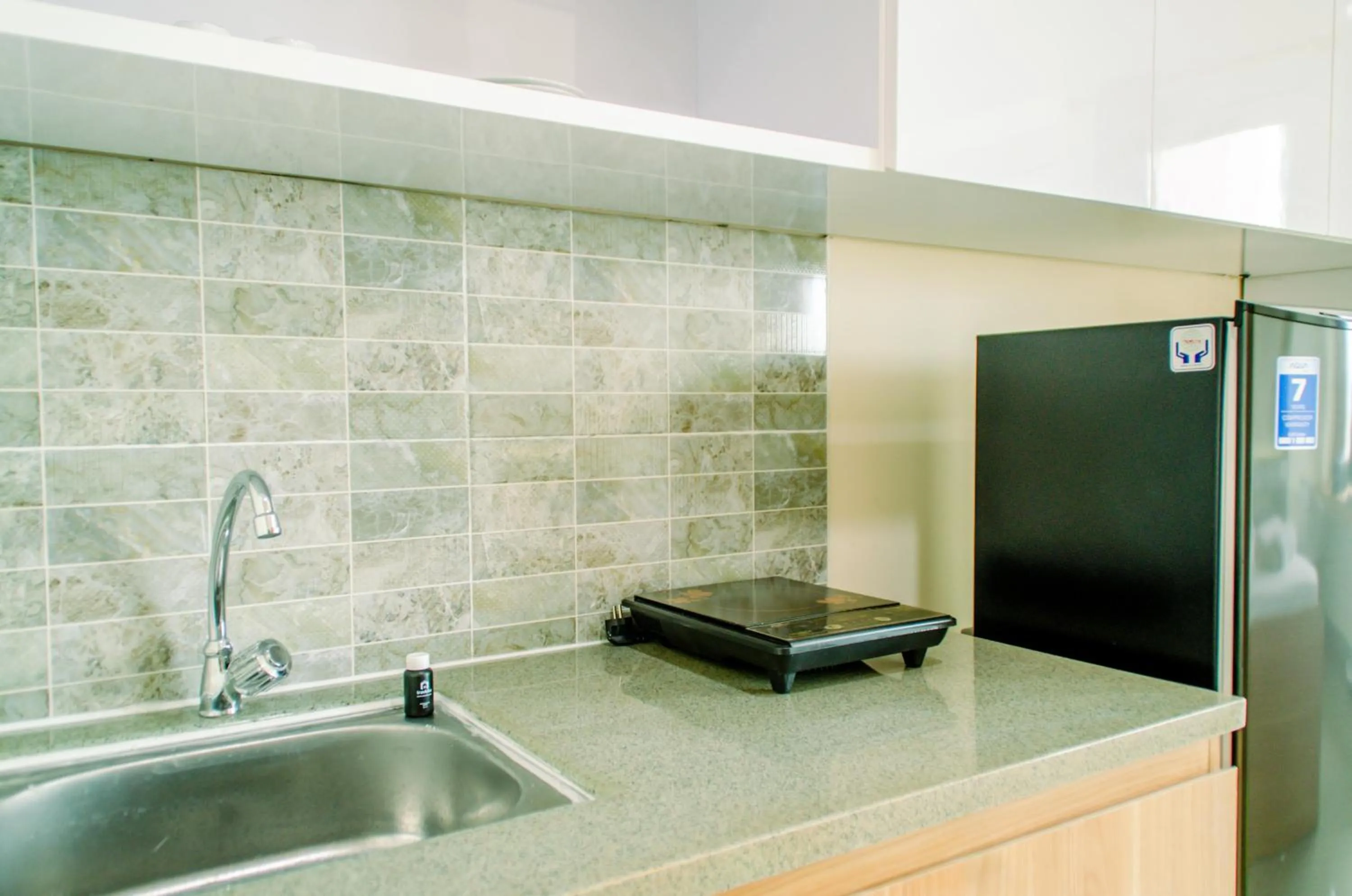 Kitchen or kitchenette in Cozy and Nice Studio at Apartment B Residence By Travelio