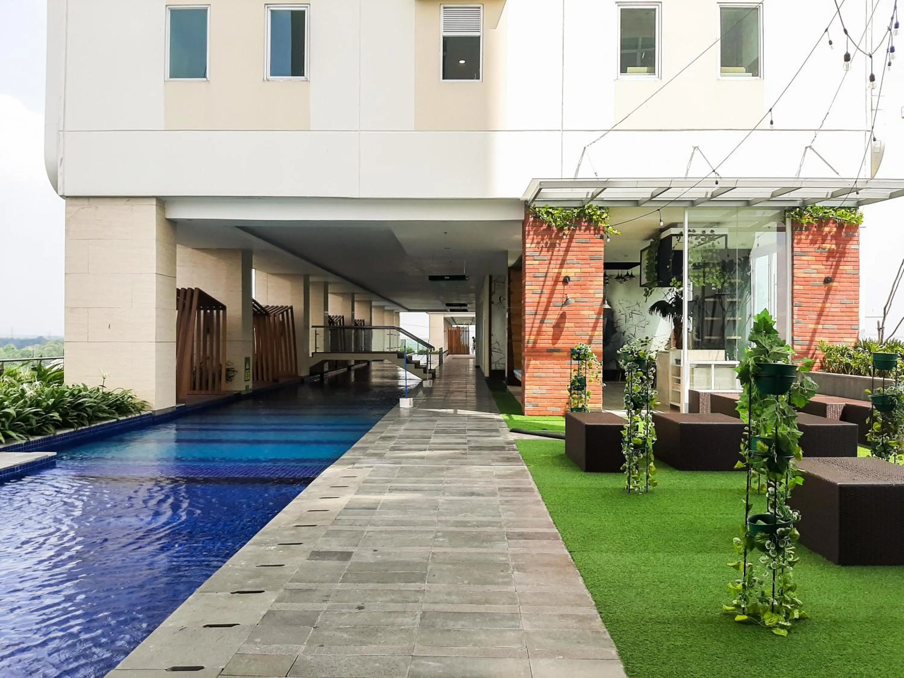 Swimming pool in Cozy and Nice Studio at Apartment B Residence By Travelio