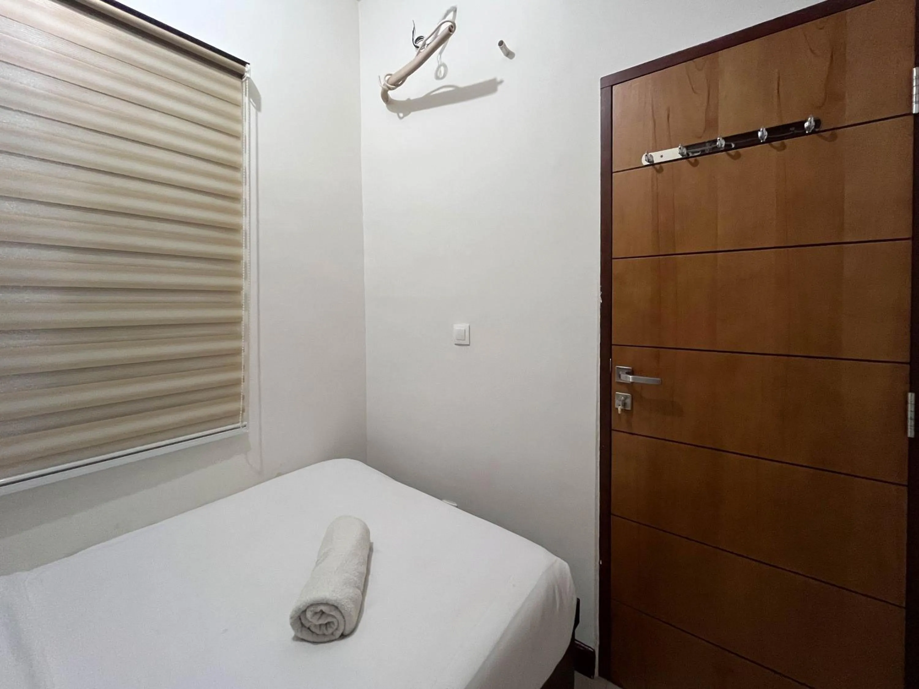 Bed in Warm and Cozy 2BR Vida View Makassar Apartment By Travelio