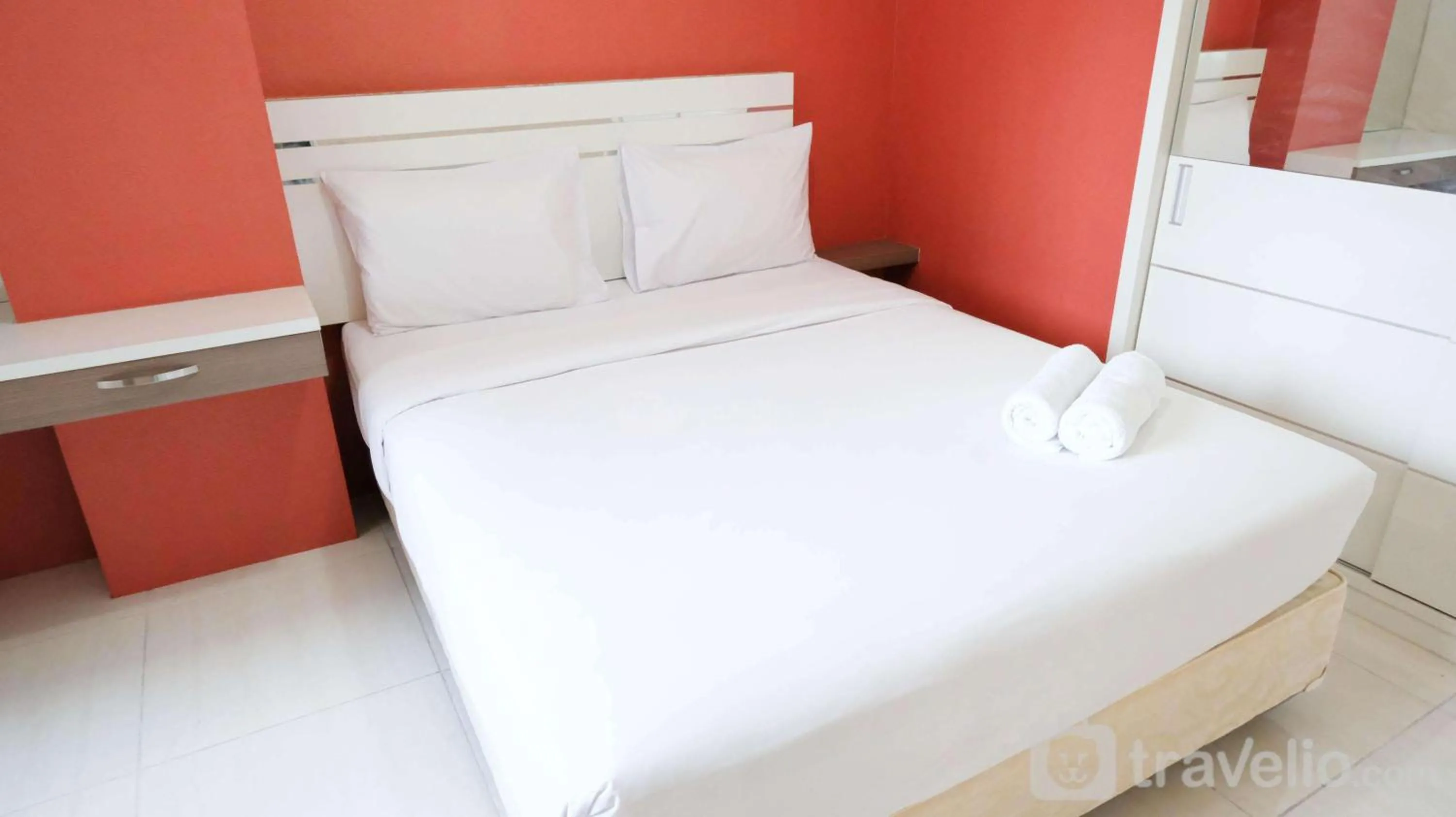 Bed in Homey 2BR at Puncak Bukit Golf Surabaya Apartment By Travelio