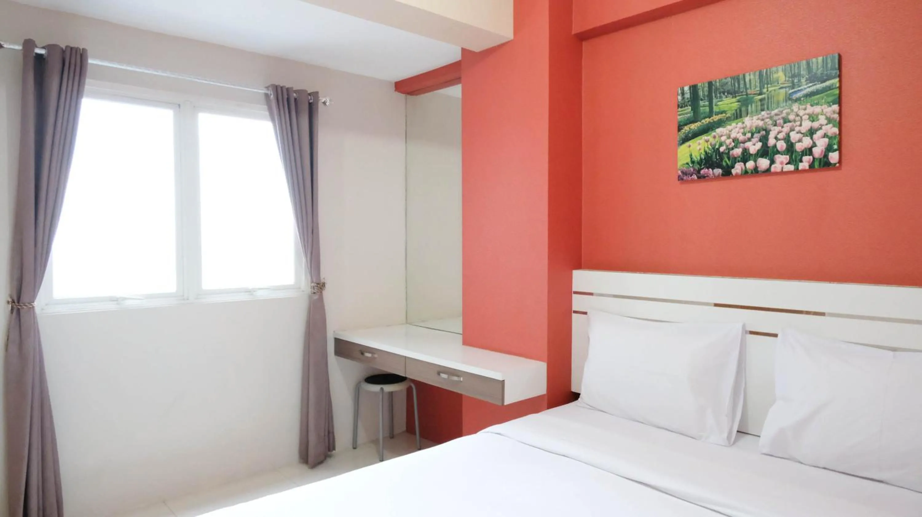 Bed in Homey 2BR at Puncak Bukit Golf Surabaya Apartment By Travelio