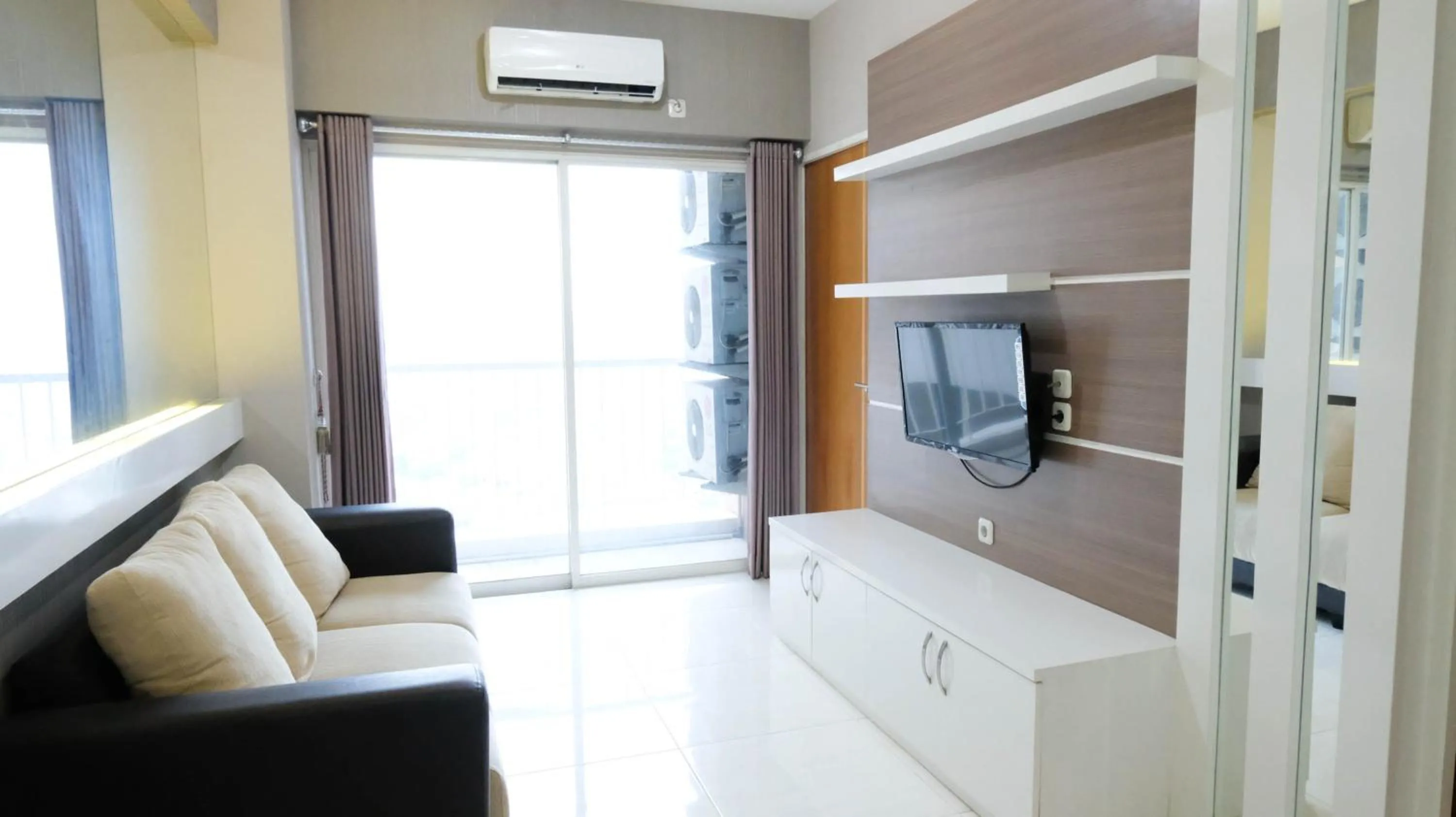 Homey 2BR at Puncak Bukit Golf Surabaya Apartment By Travelio