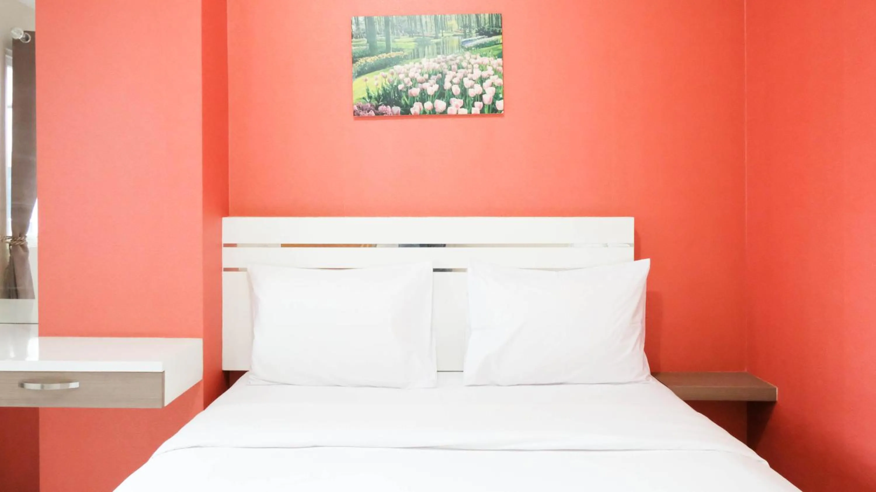 Bed in Homey 2BR at Puncak Bukit Golf Surabaya Apartment By Travelio