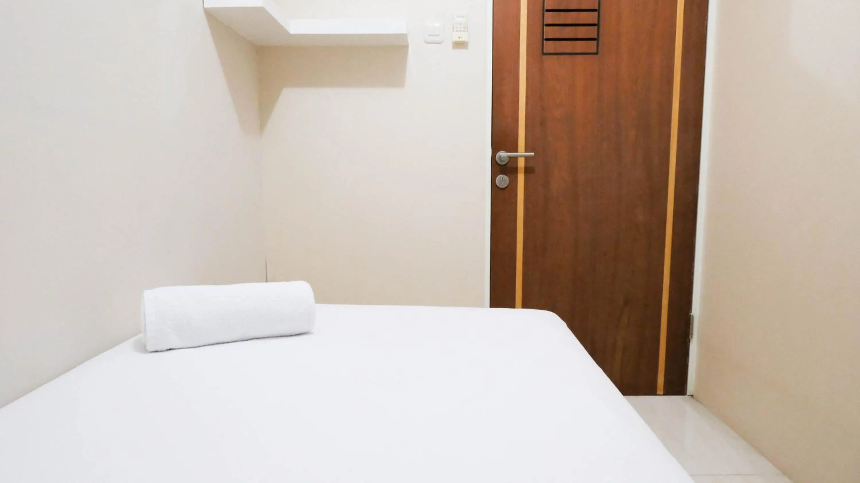 Bed in Homey 2BR at Puncak Bukit Golf Surabaya Apartment By Travelio