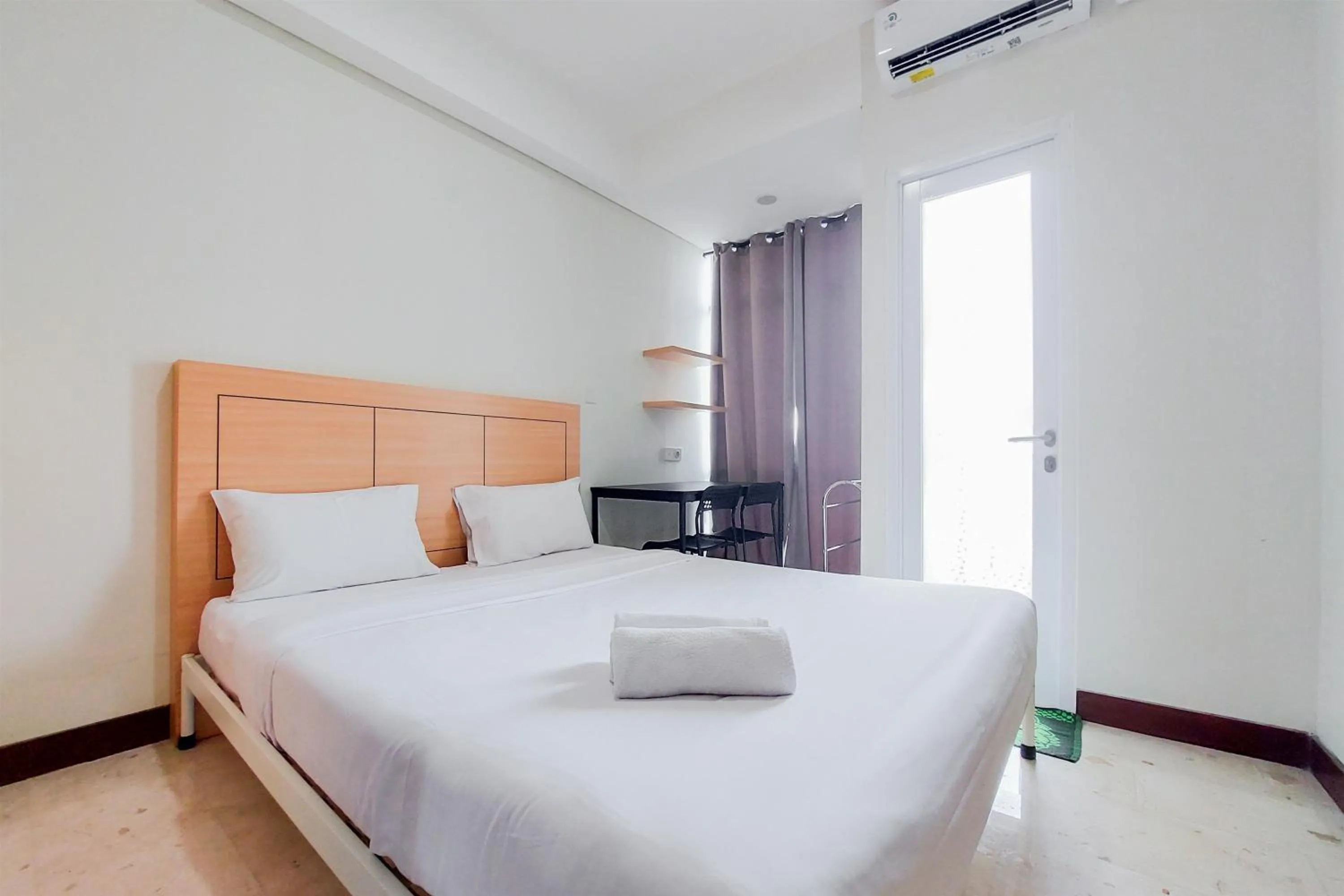 Bed in Warm and Simply Look Studio Apartment at B Residence By Travelio