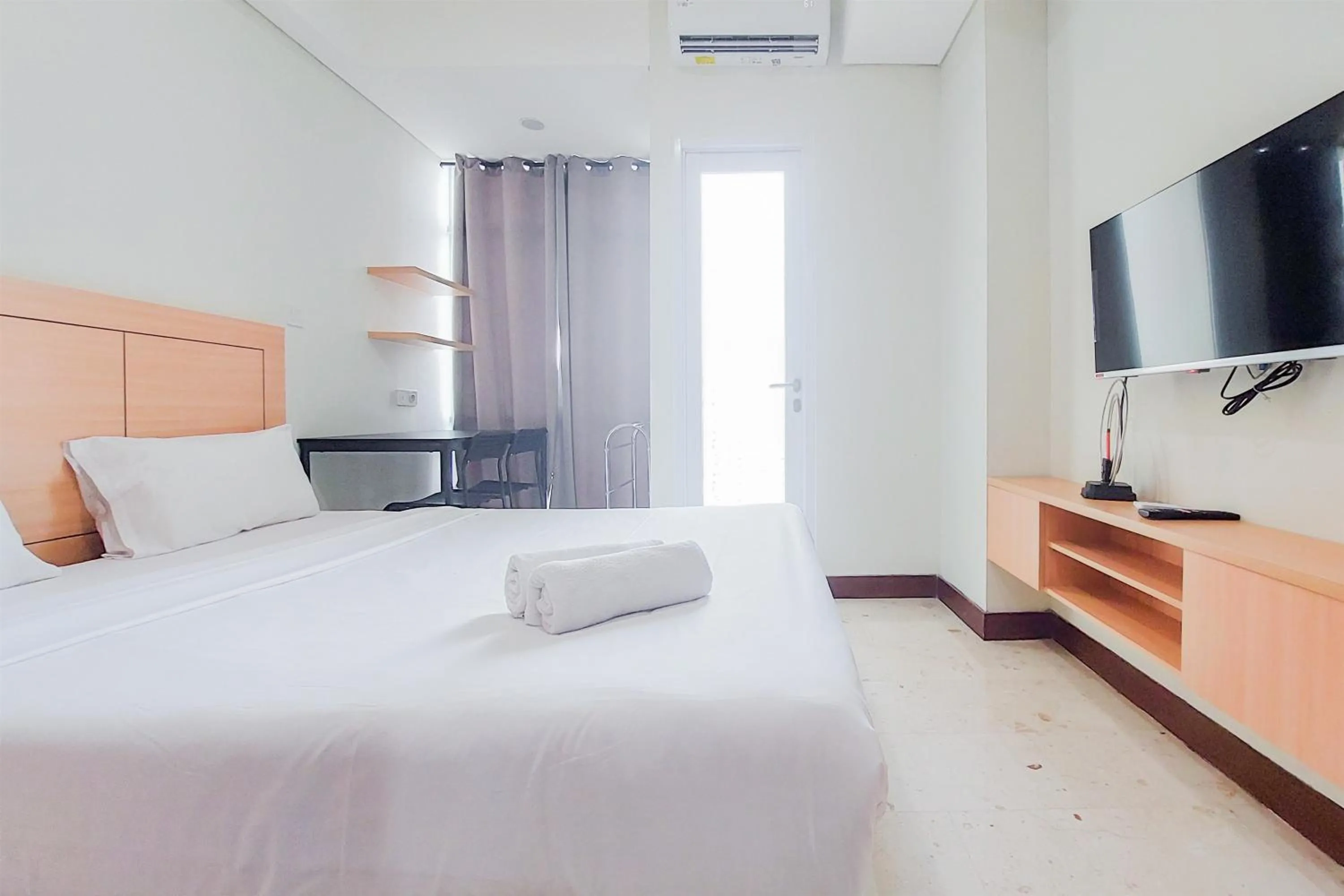 Bed in Warm and Simply Look Studio Apartment at B Residence By Travelio