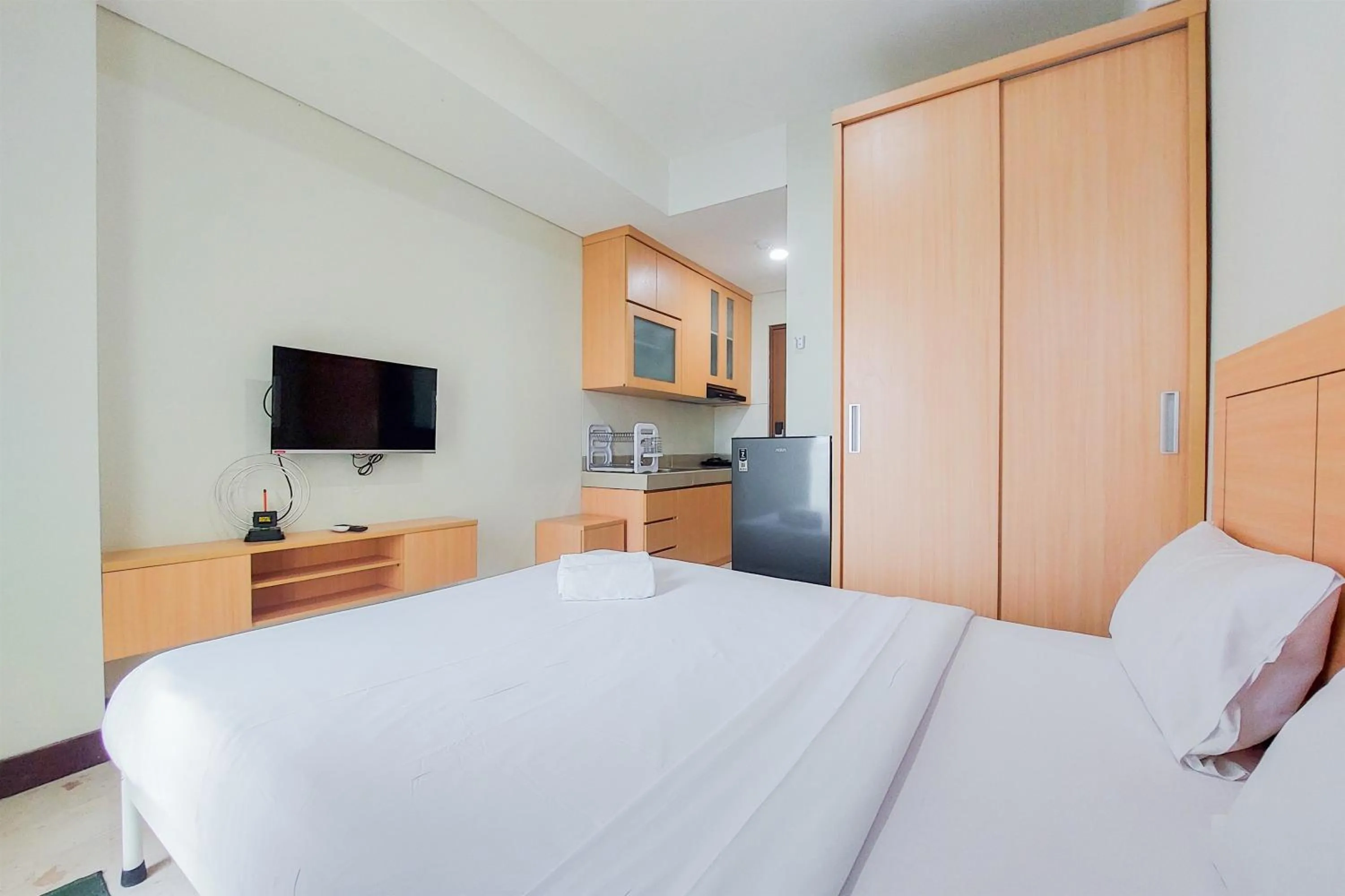 Bed in Warm and Simply Look Studio Apartment at B Residence By Travelio