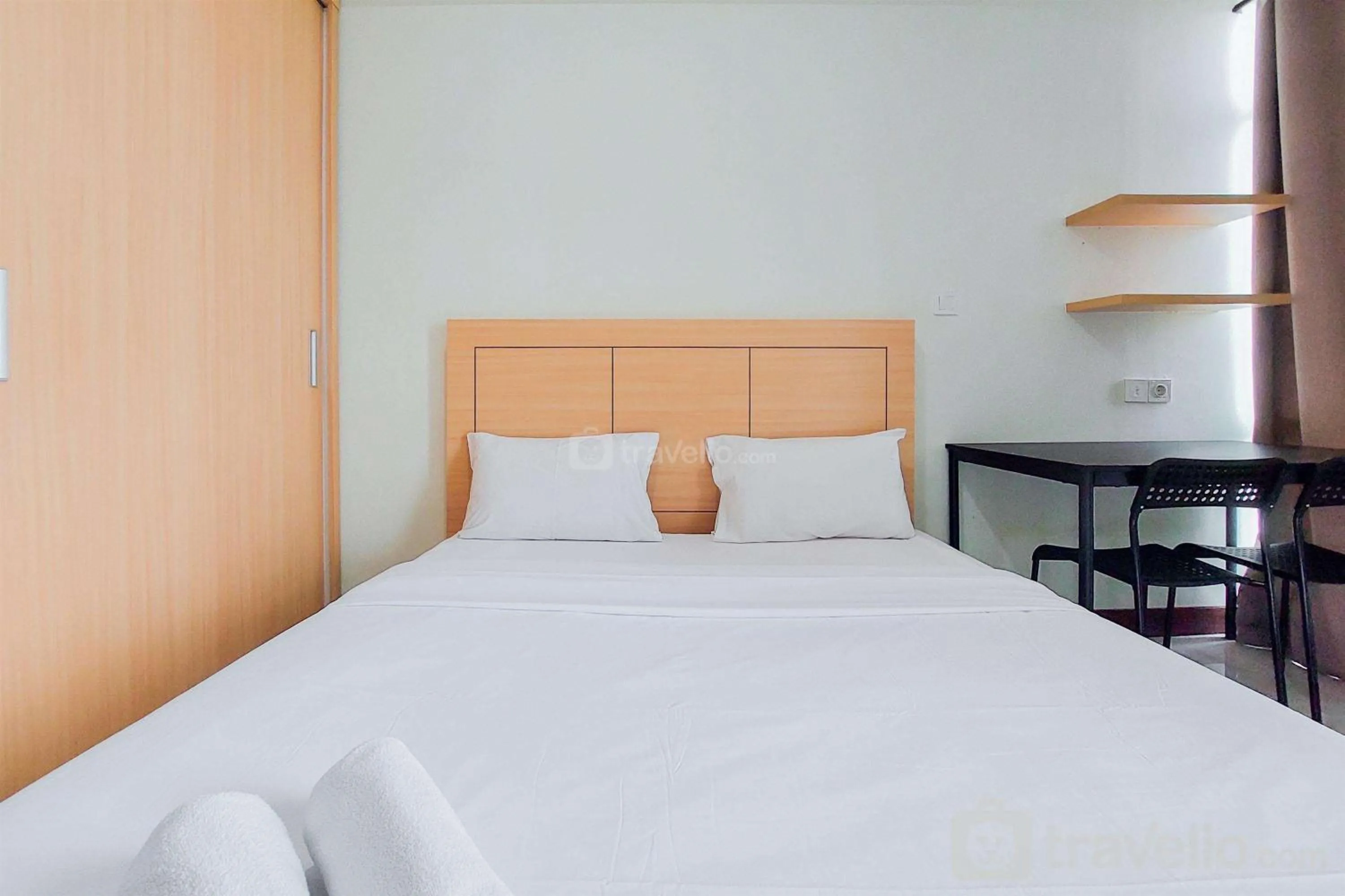 Bed in Warm and Simply Look Studio Apartment at B Residence By Travelio