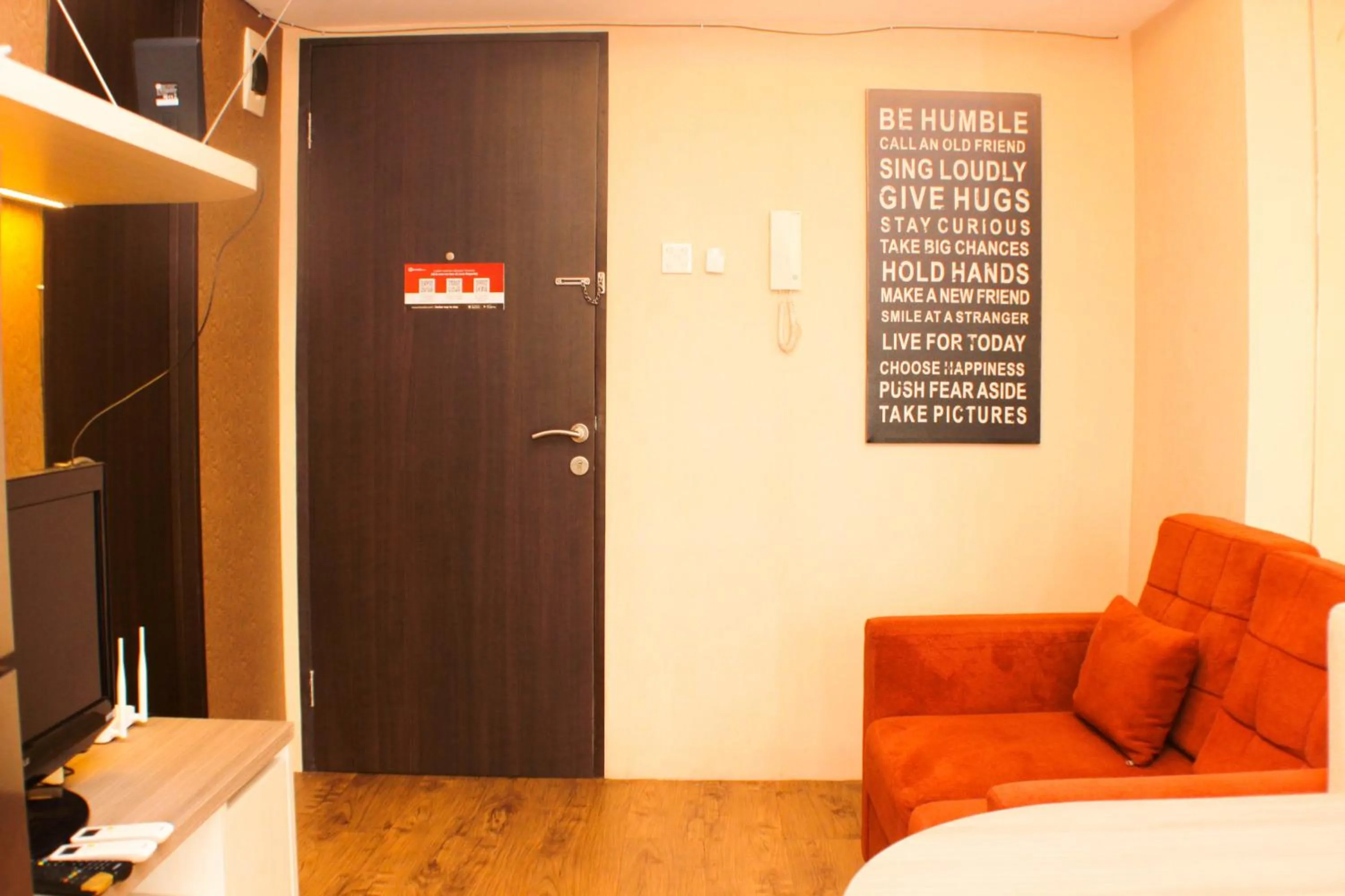 Living room in Strategic and Simply 2BR at Bassura City Apartment By Travelio