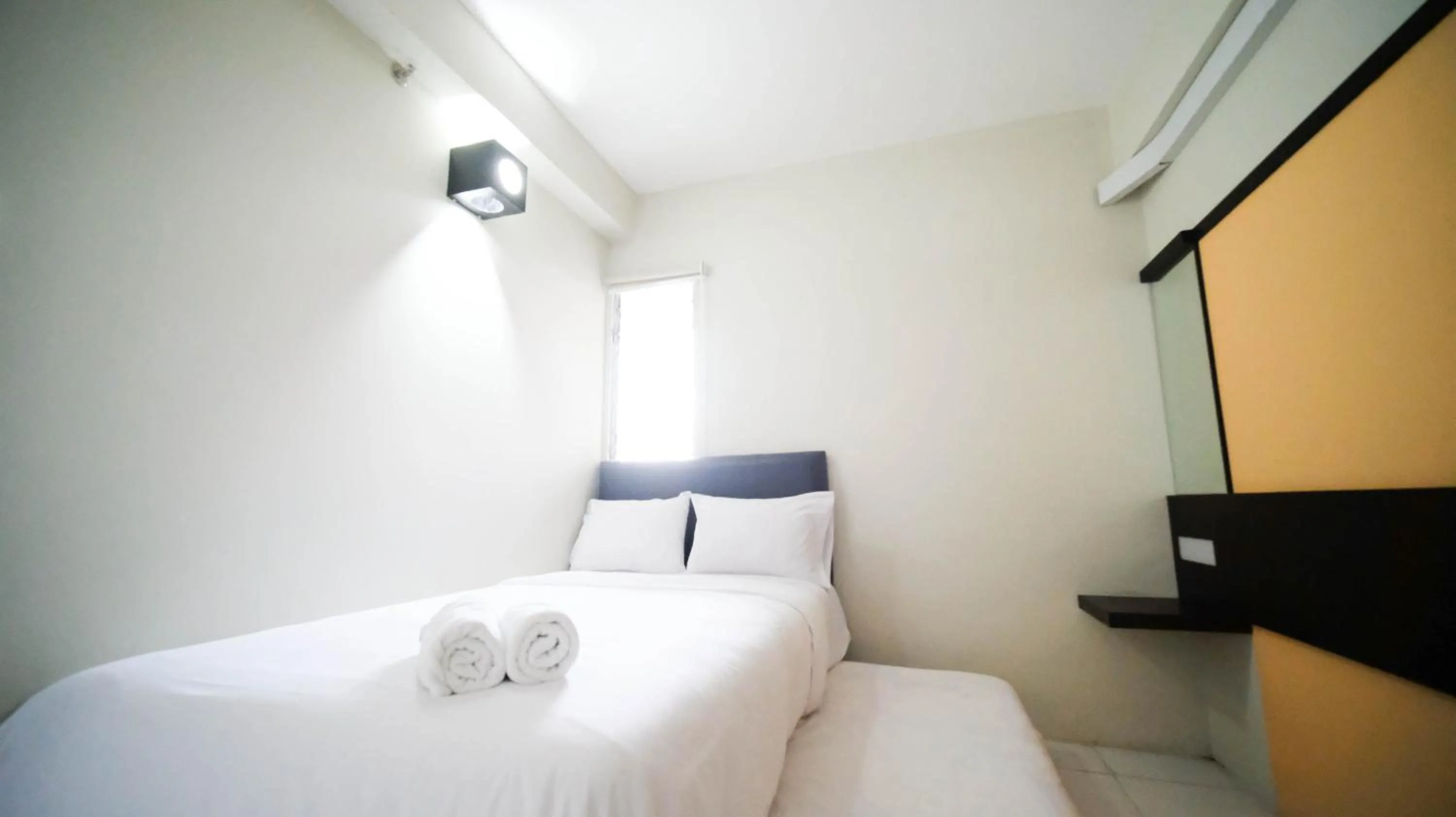 Bed in Homey and Comfy 2BR at Dian Regency Apartment By Travelio