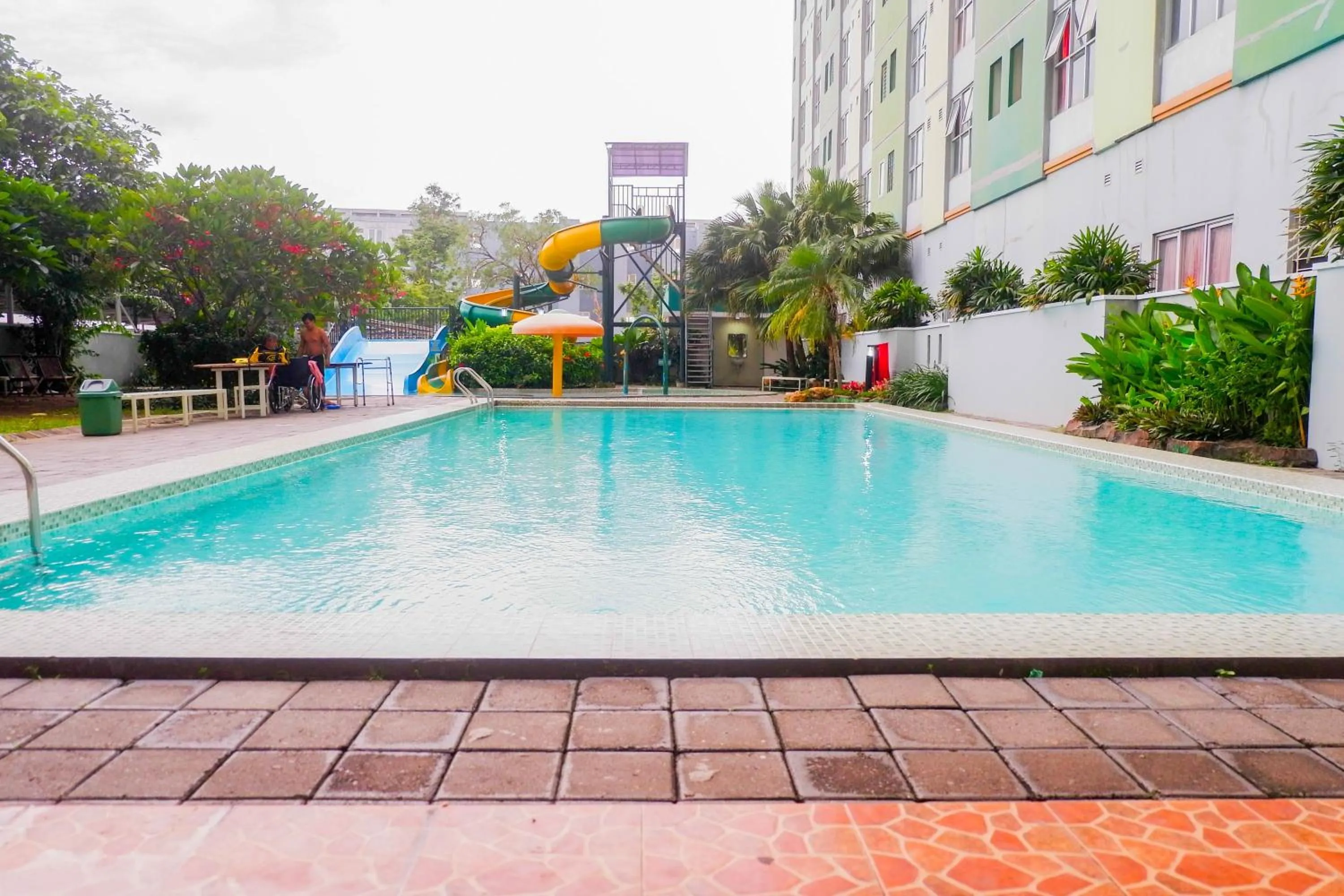 Swimming pool in Homey and Comfy 2BR at Dian Regency Apartment By Travelio
