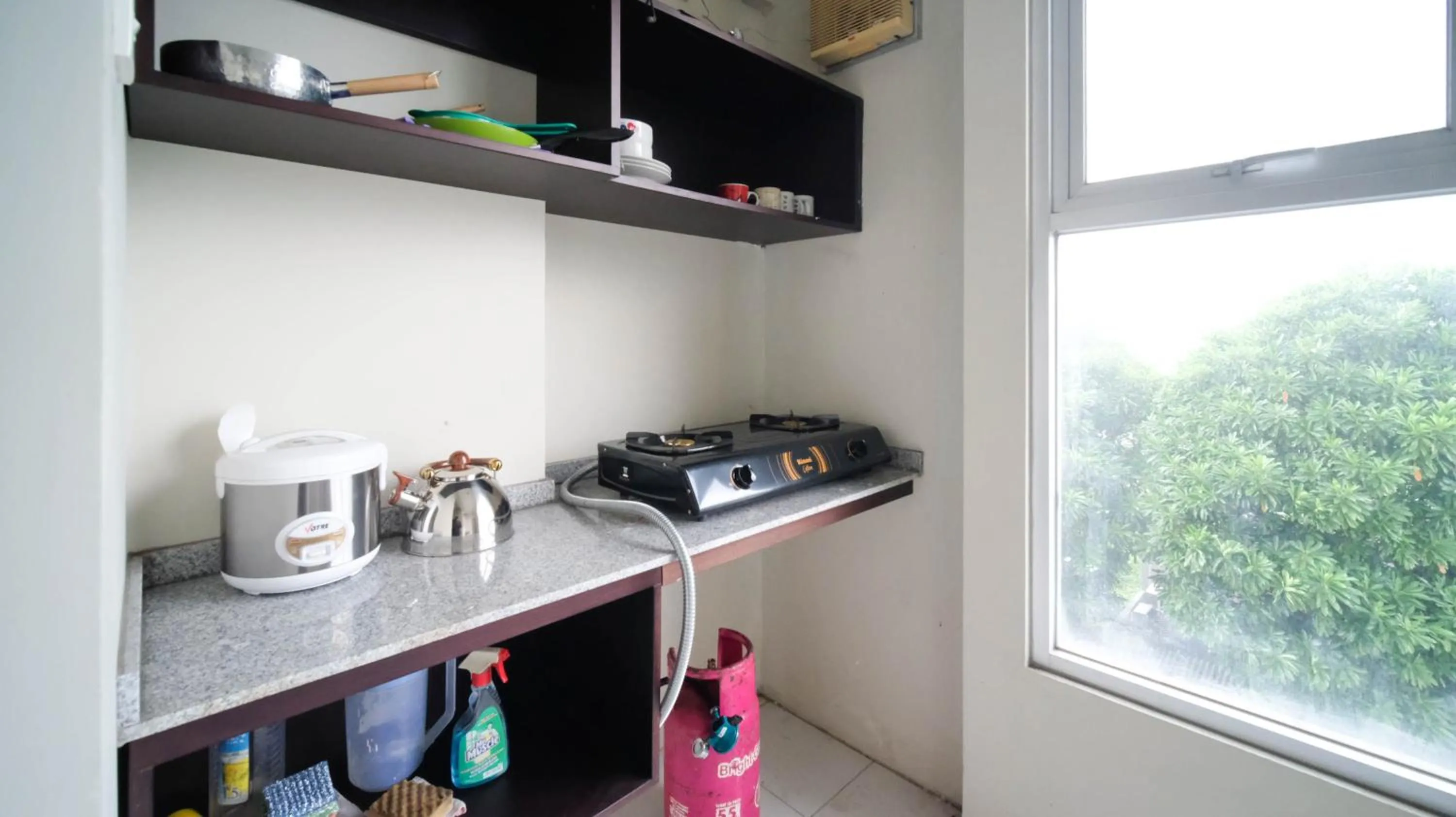 Kitchen or kitchenette in Homey and Comfy 2BR at Dian Regency Apartment By Travelio
