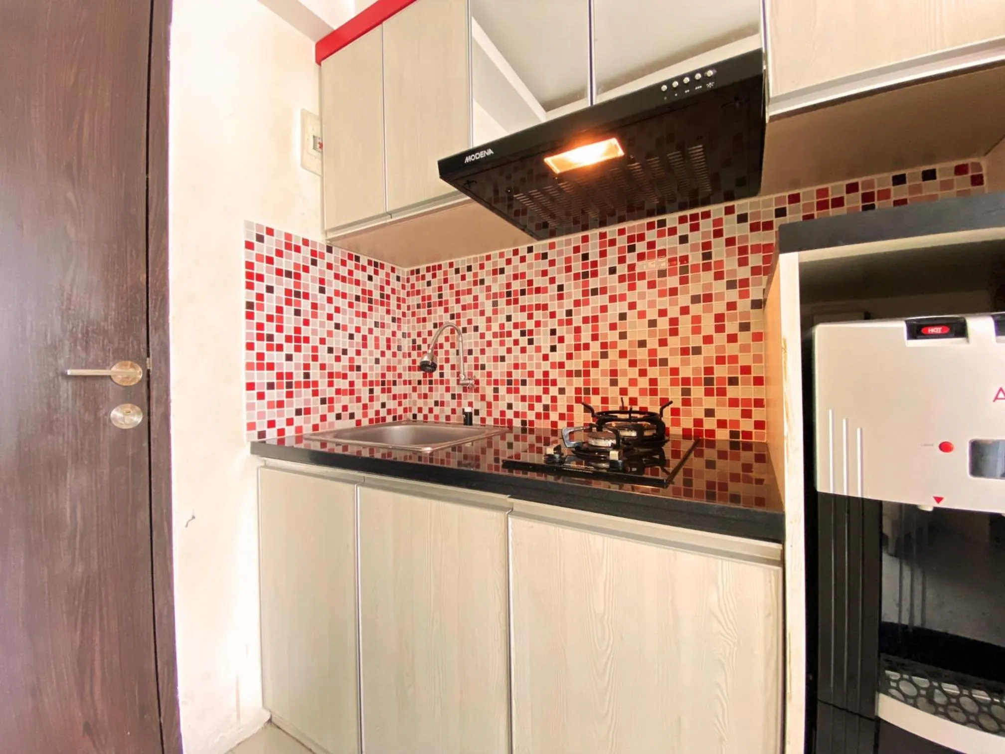 Kitchen or kitchenette in Spacious 2BR at Jarrdin Cihampelas Apartment By Travelio