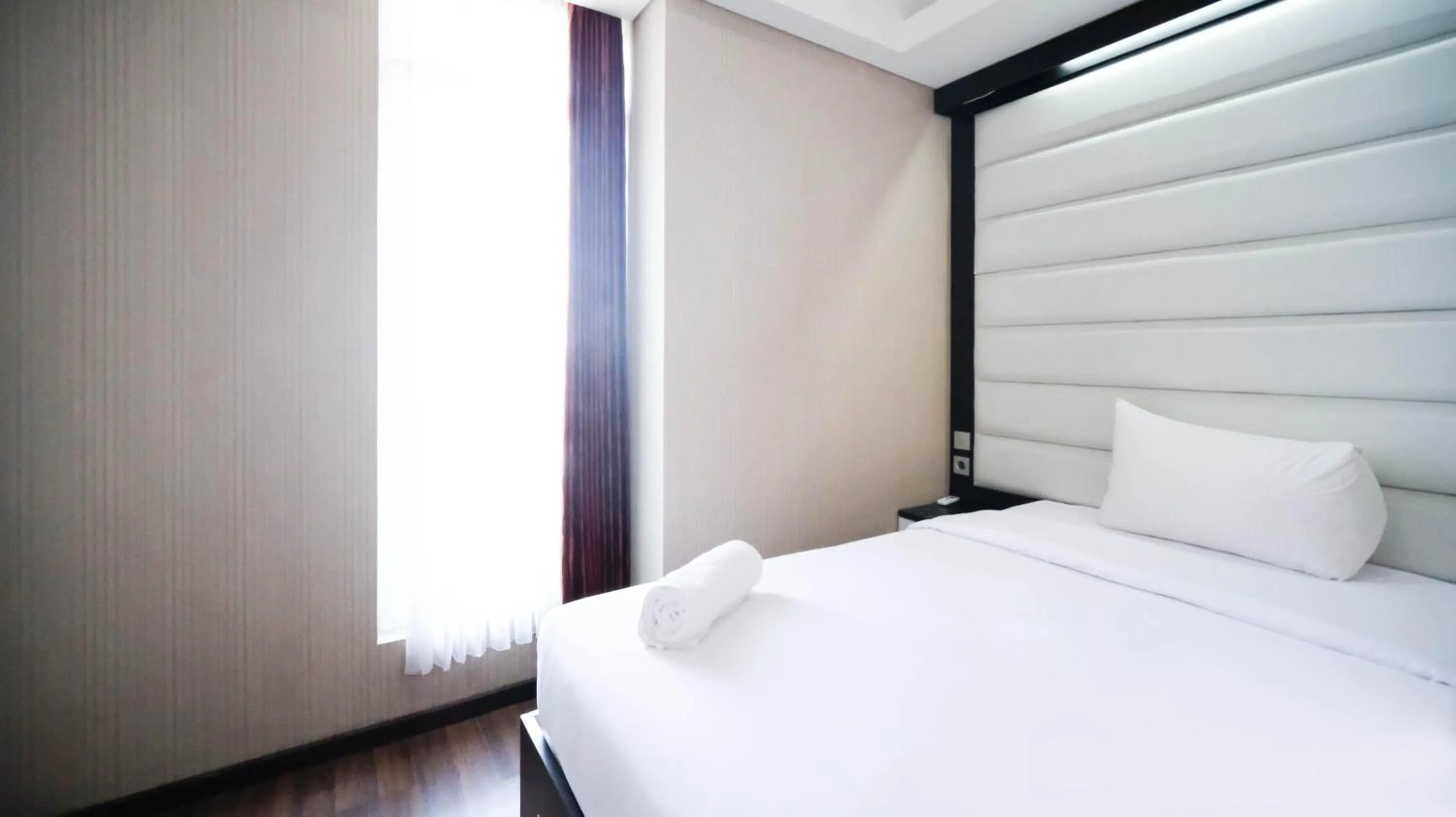 Bed in Strategic and Comfy 2BR Apartment at Trillium Residence By Travelio
