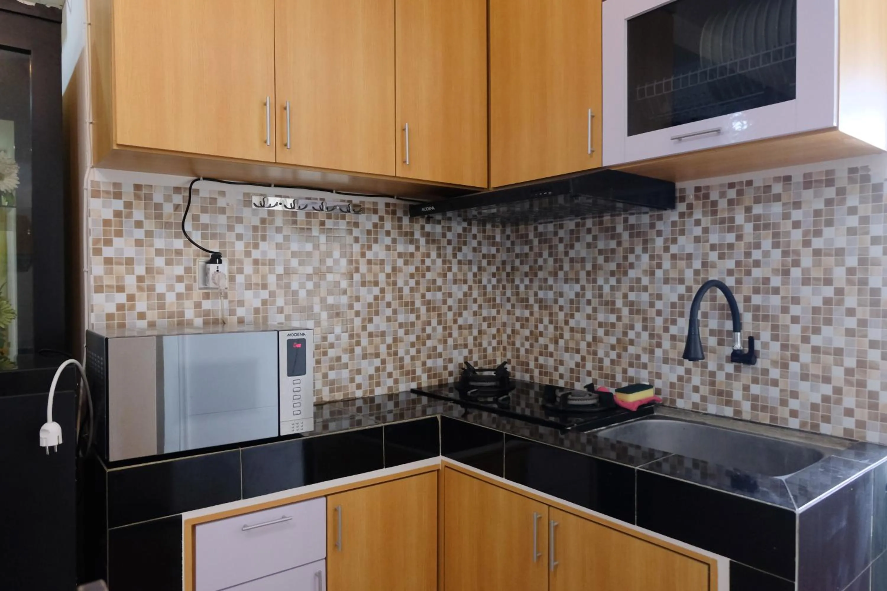 Kitchen or kitchenette in Spacious and Modern 3BR Apartment at Gateway Ahmad Yani Cicadas By Travelio