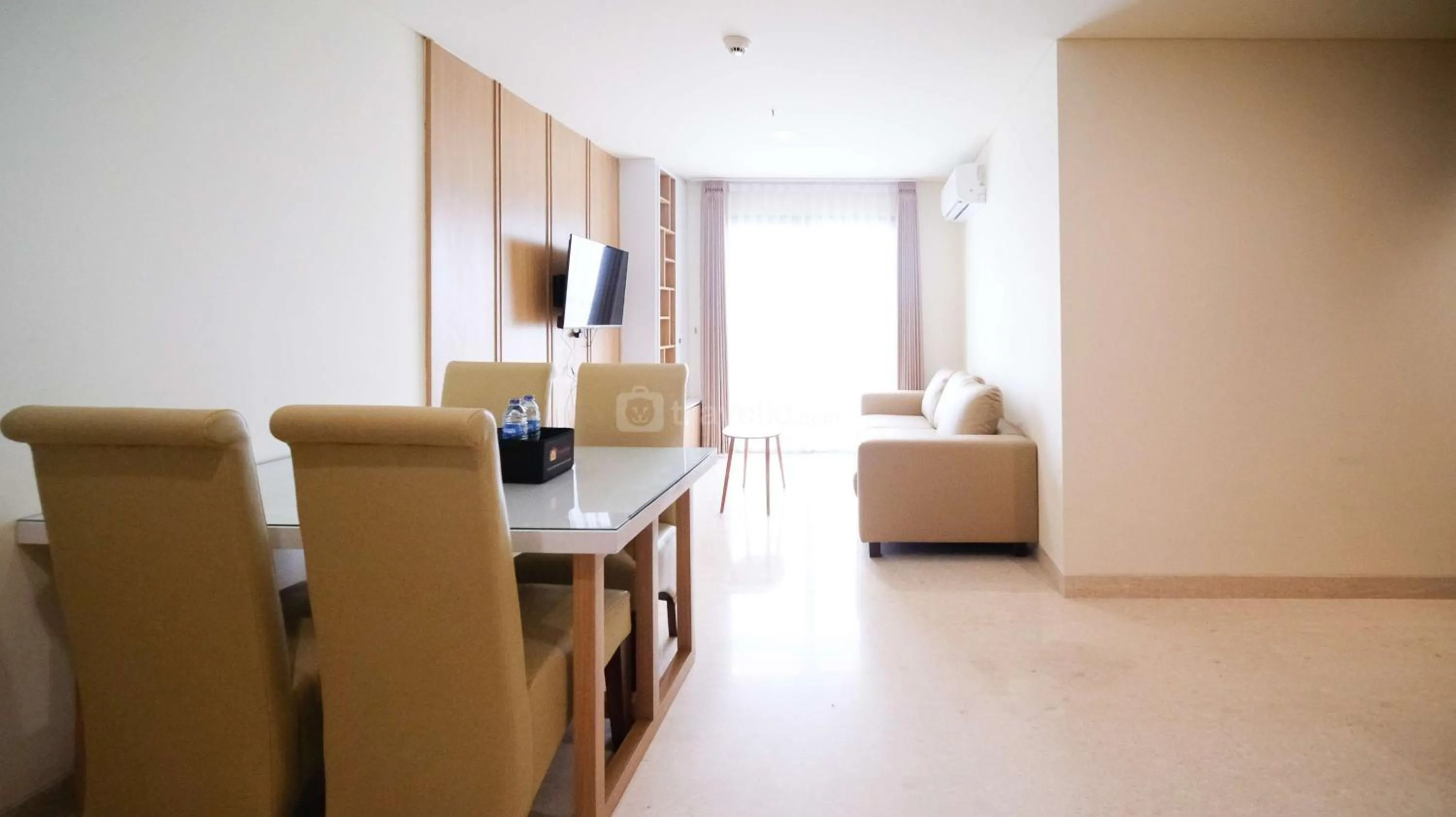 Living room in Best Location and Strategic 2BR at Praxis Apartment By Travelio