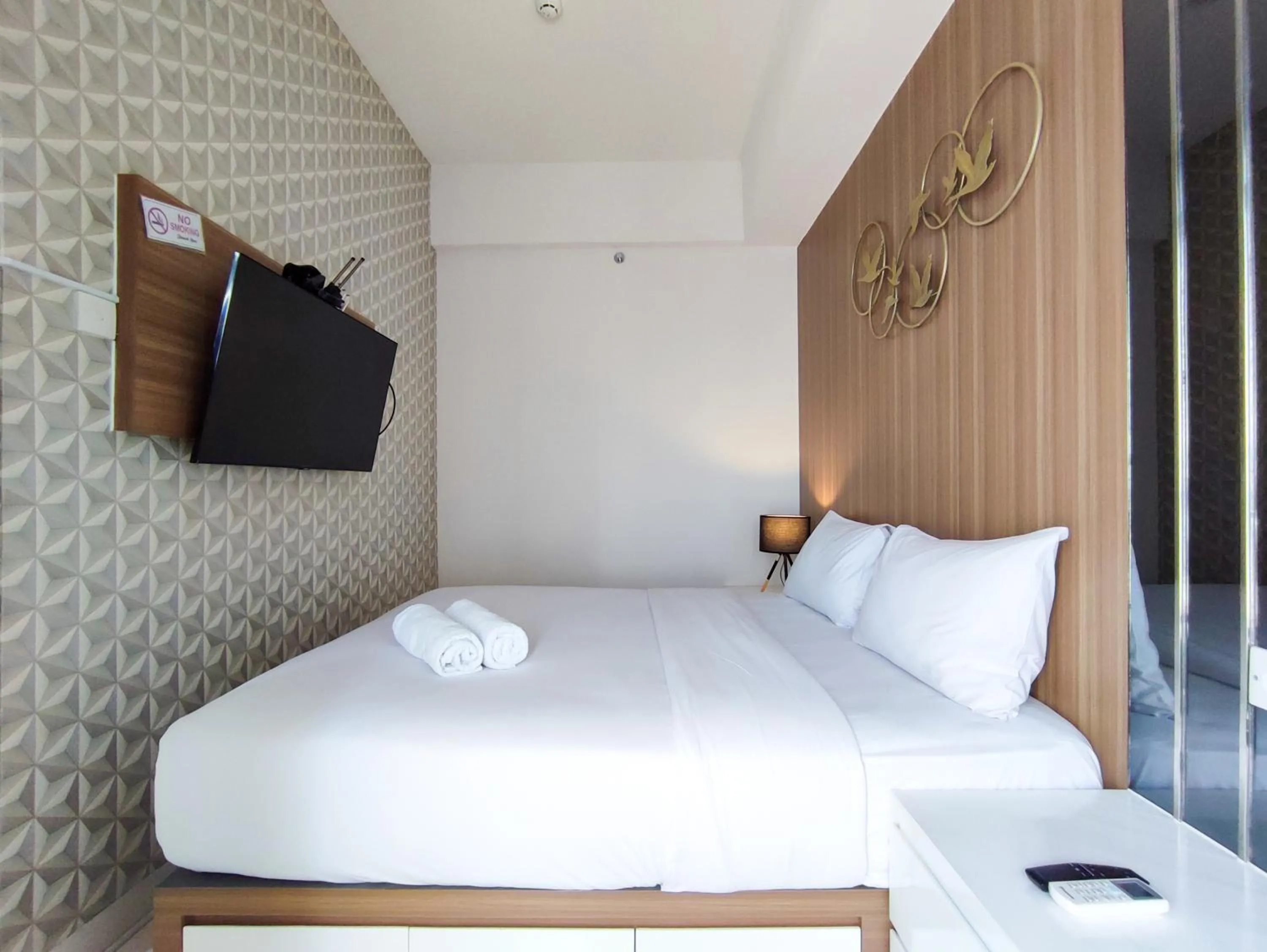 Bed in Fancy and Nice 1BR with Extra Room at Amartha View Apartment By Travelio