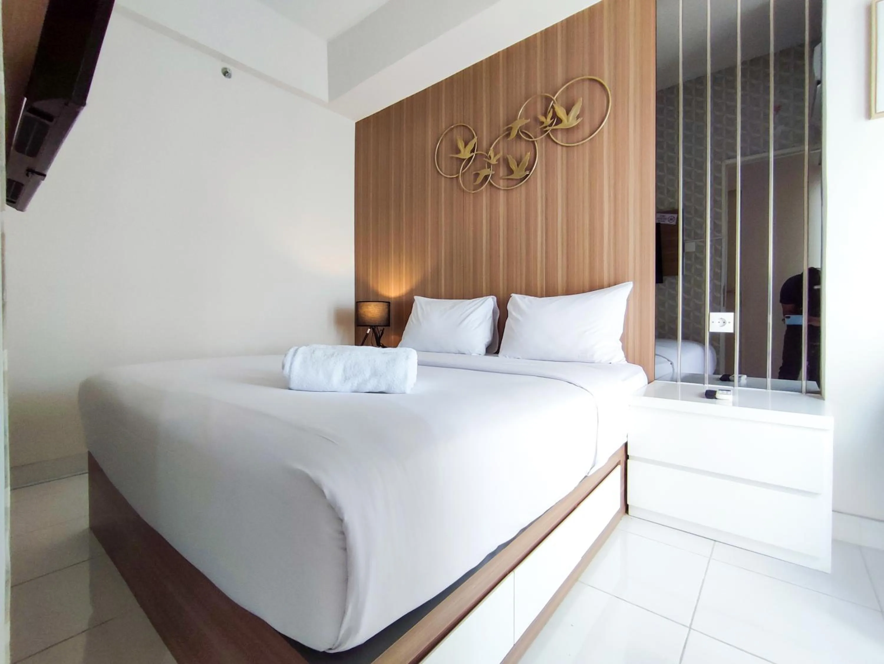 Bed in Fancy and Nice 1BR with Extra Room at Amartha View Apartment By Travelio