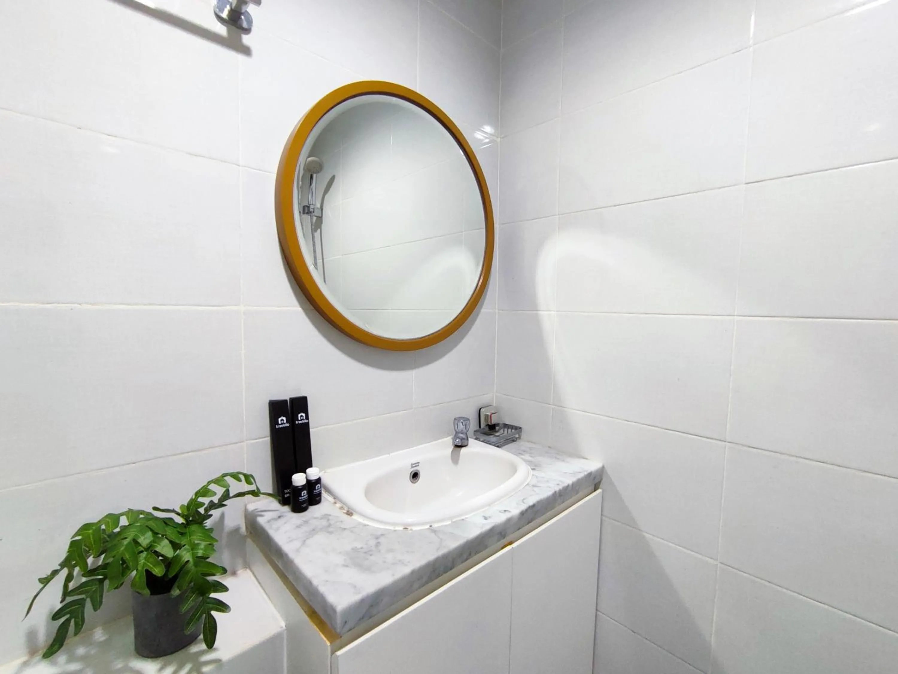 Bathroom in Fancy and Nice 1BR with Extra Room at Amartha View Apartment By Travelio