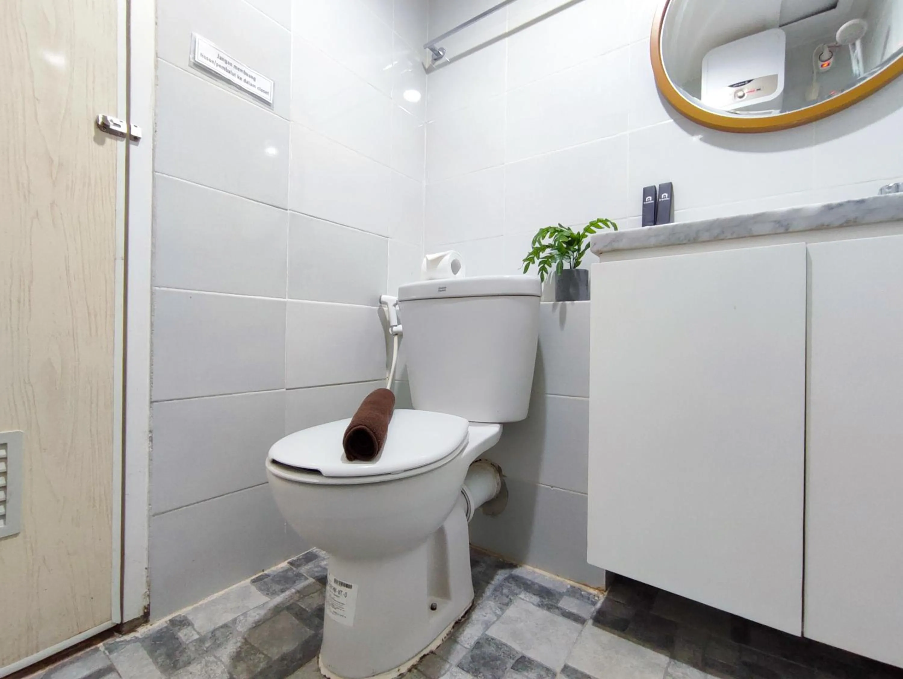 Bathroom in Fancy and Nice 1BR with Extra Room at Amartha View Apartment By Travelio