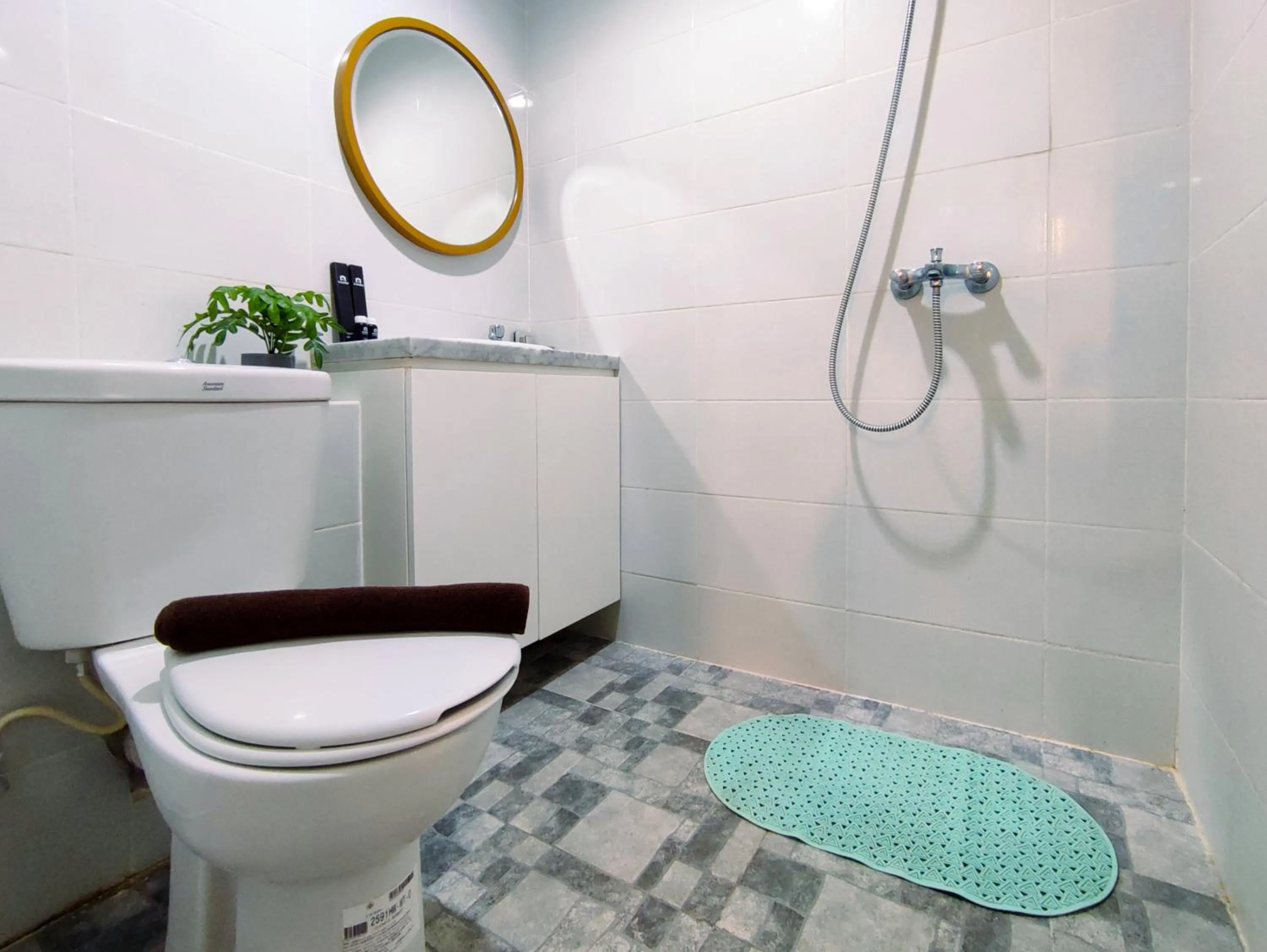 Bathroom in Fancy and Nice 1BR with Extra Room at Amartha View Apartment By Travelio