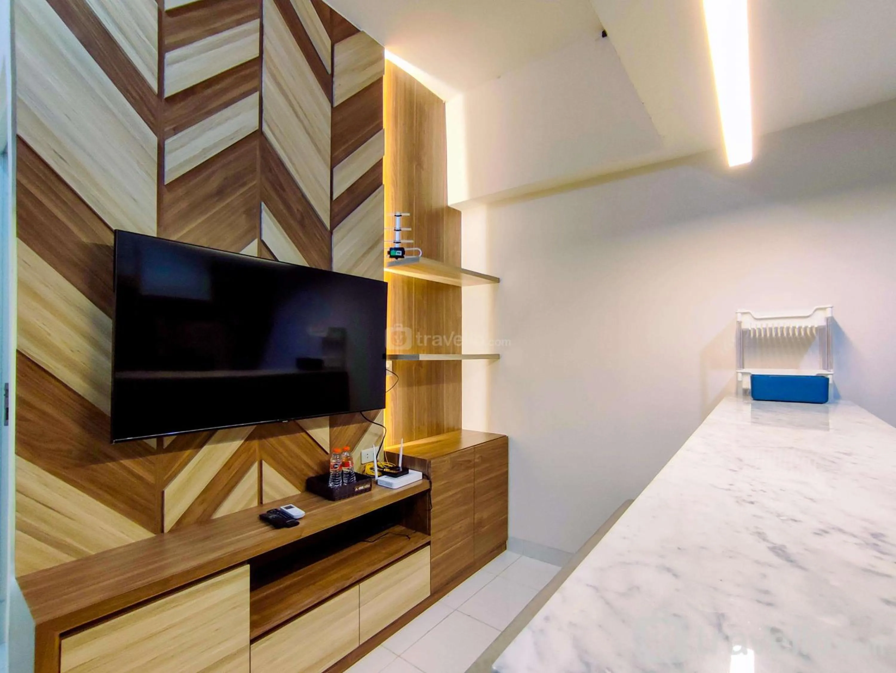 Living room in Fancy and Nice 1BR with Extra Room at Amartha View Apartment By Travelio