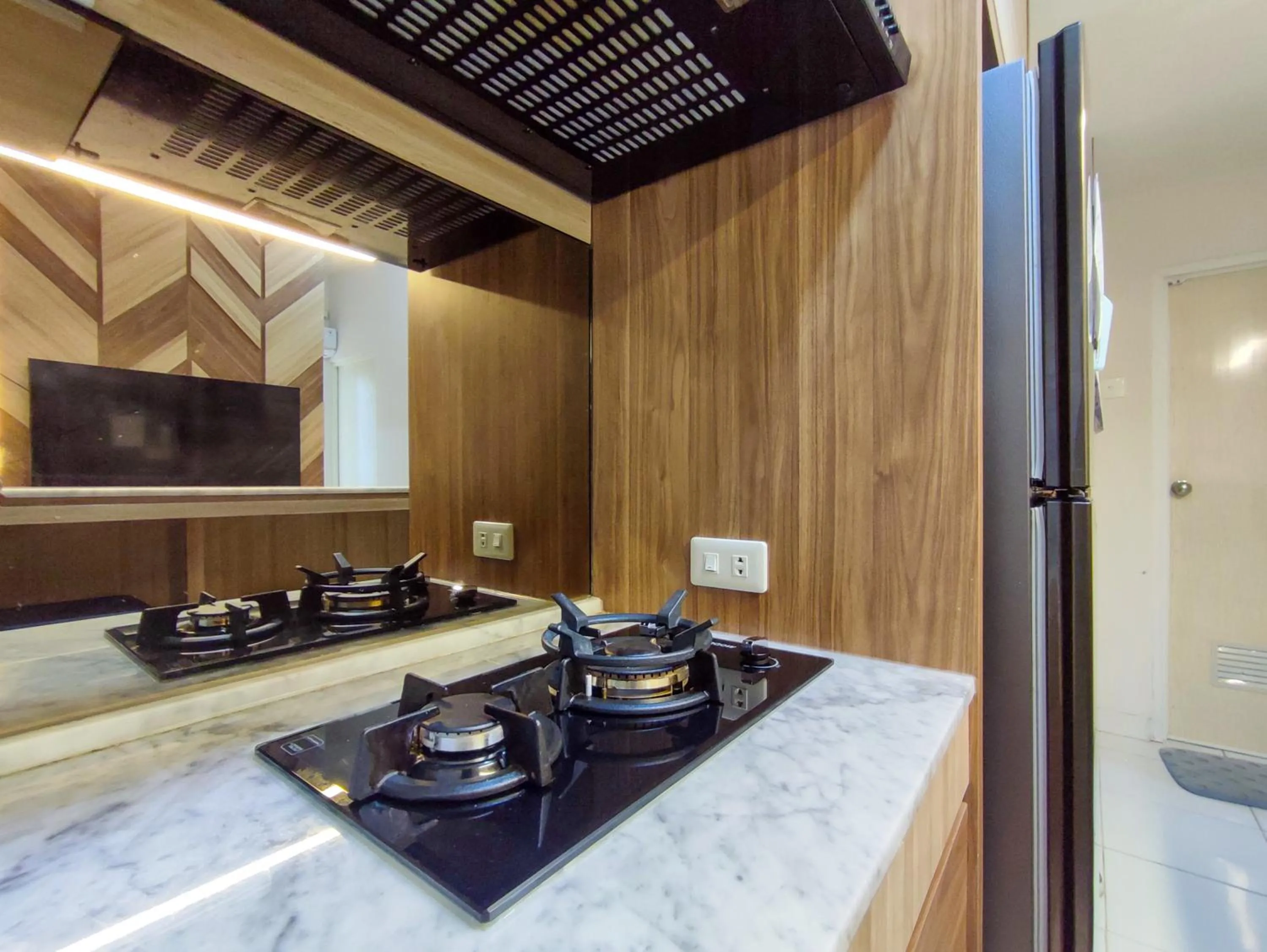 Kitchen or kitchenette in Fancy and Nice 1BR with Extra Room at Amartha View Apartment By Travelio
