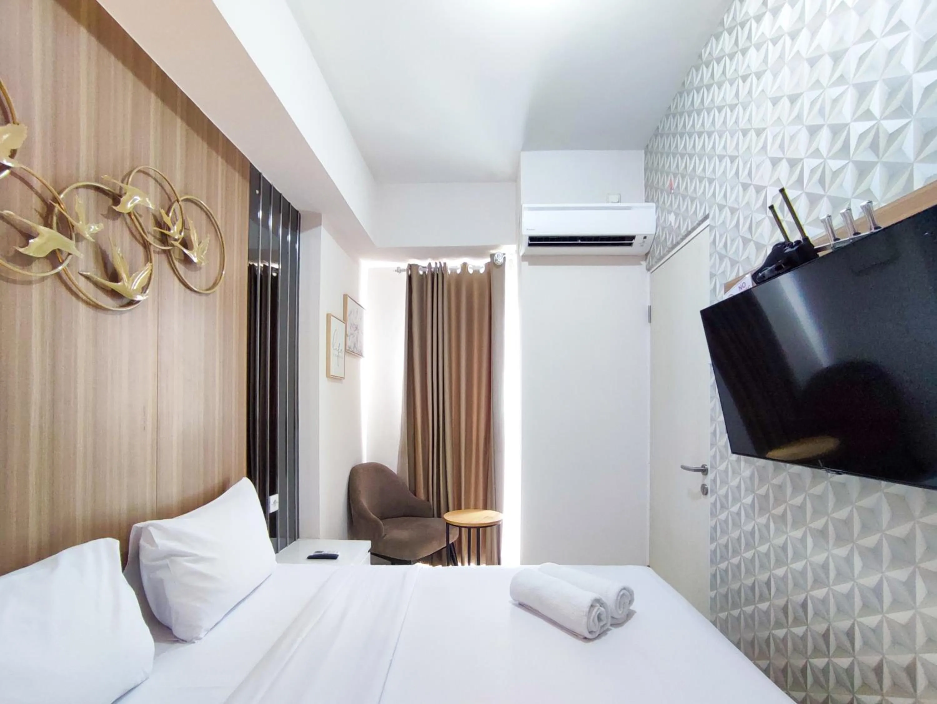 Bed in Fancy and Nice 1BR with Extra Room at Amartha View Apartment By Travelio