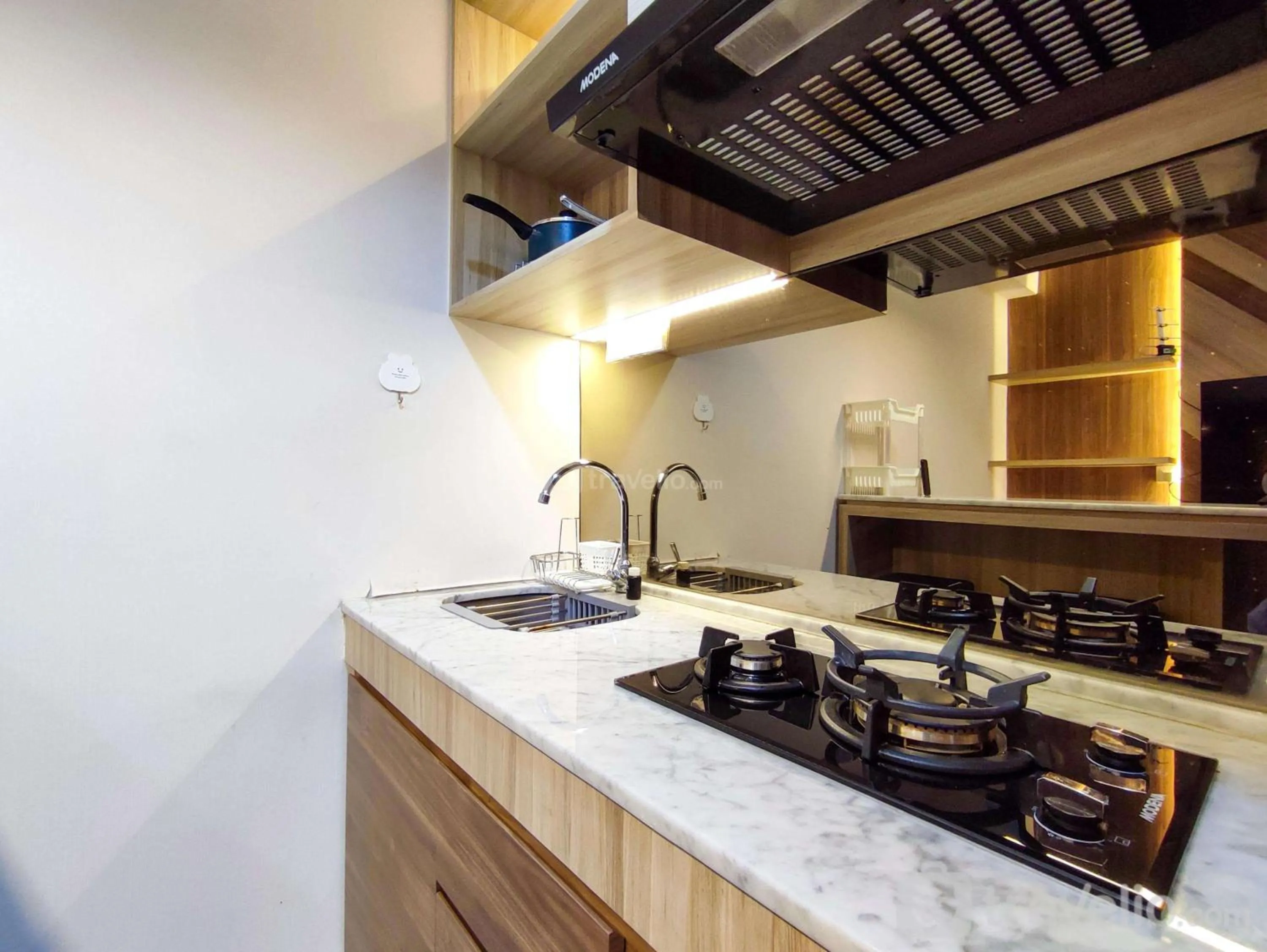 Bed in Fancy and Nice 1BR with Extra Room at Amartha View Apartment By Travelio