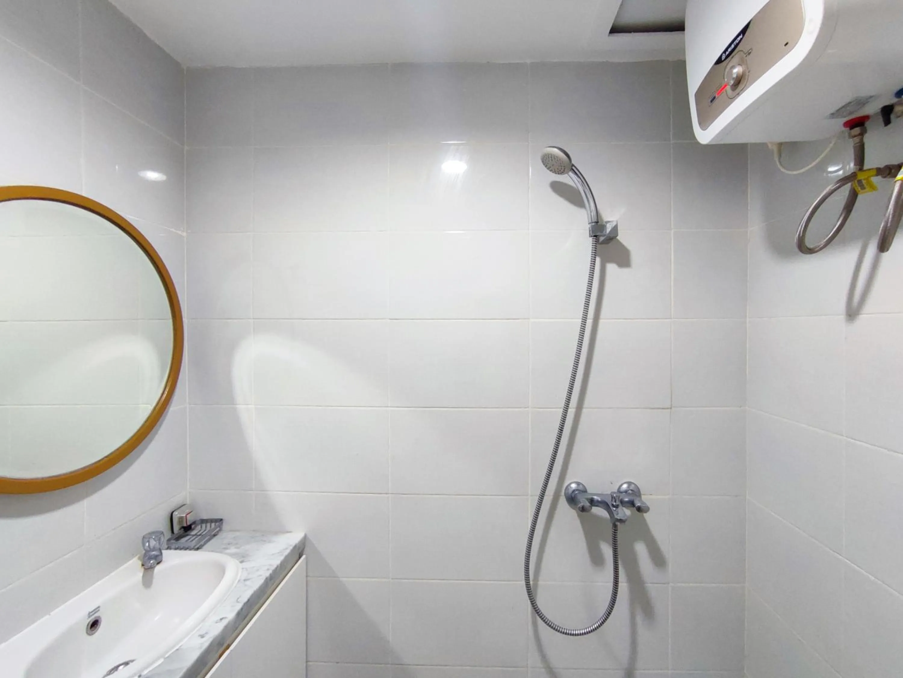 Bathroom in Fancy and Nice 1BR with Extra Room at Amartha View Apartment By Travelio
