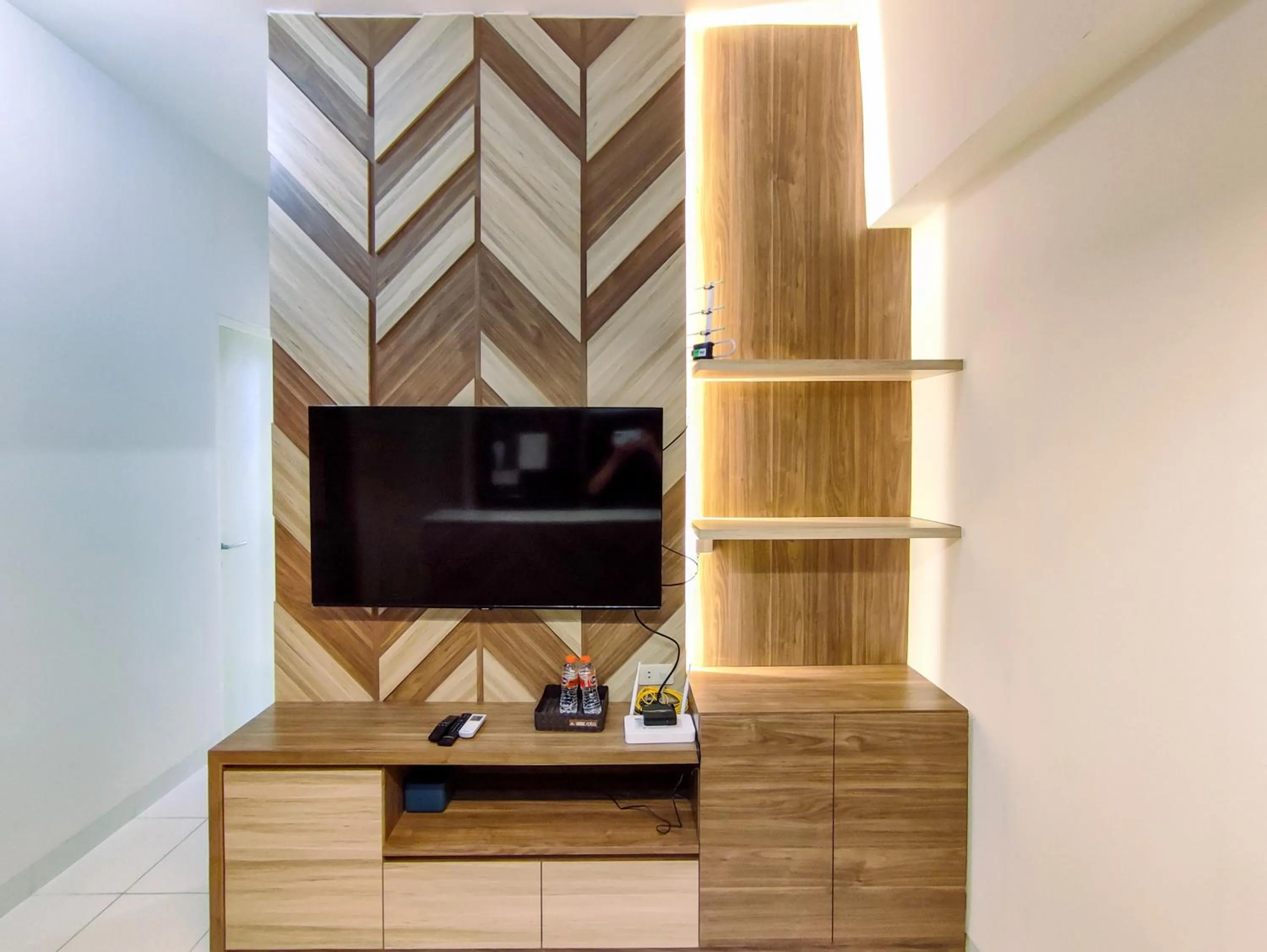 Living room in Fancy and Nice 1BR with Extra Room at Amartha View Apartment By Travelio