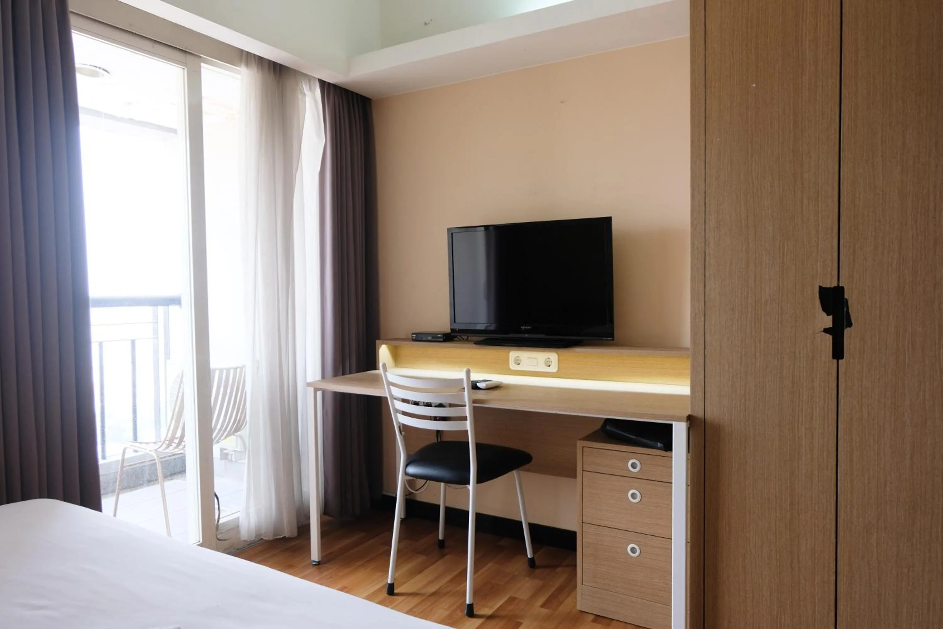 Living room, Bed in Strategic and Comfy 1BR at Braga City Walk Apartment By Travelio