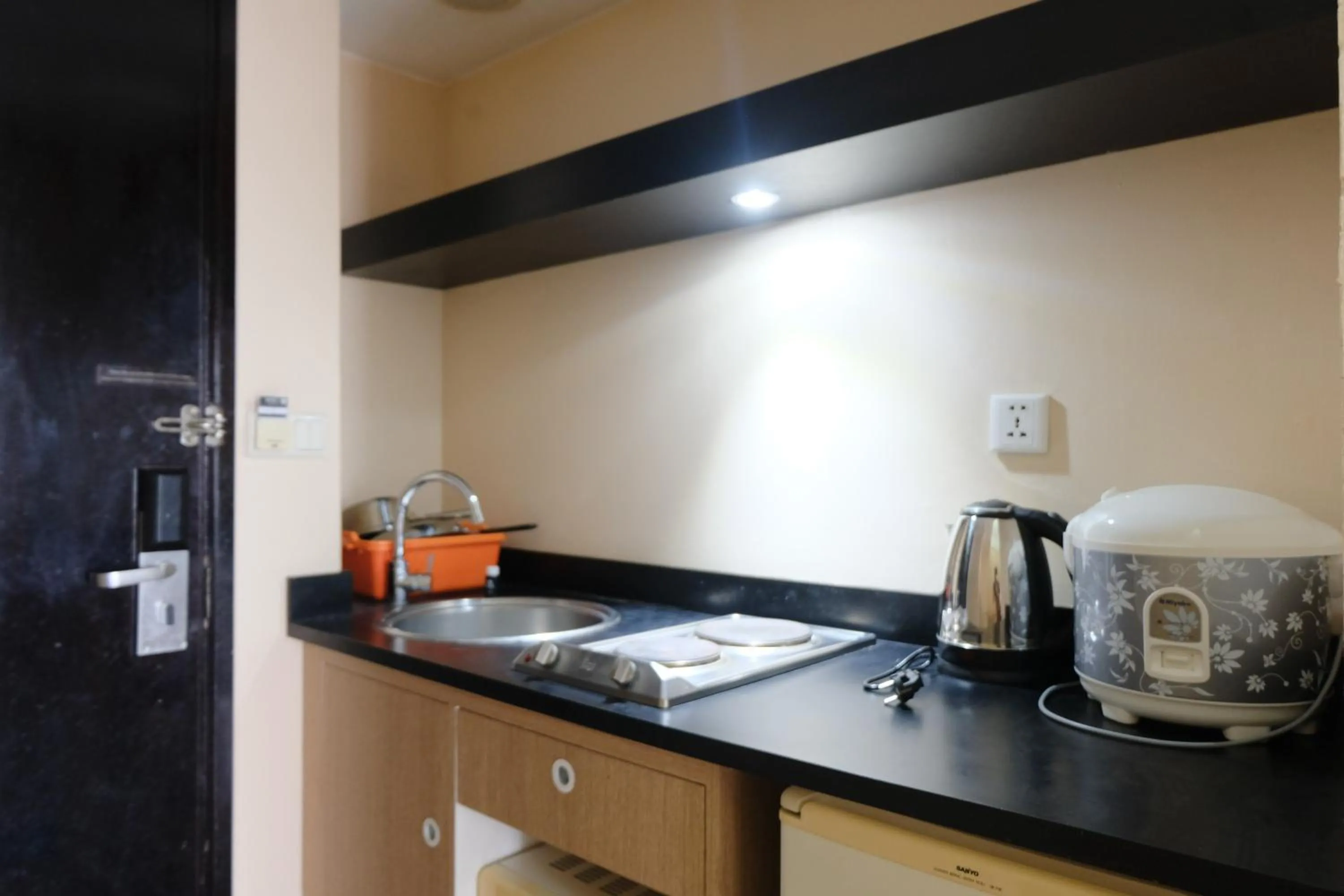 kitchen in Strategic and Comfy 1BR at Braga City Walk Apartment By Travelio