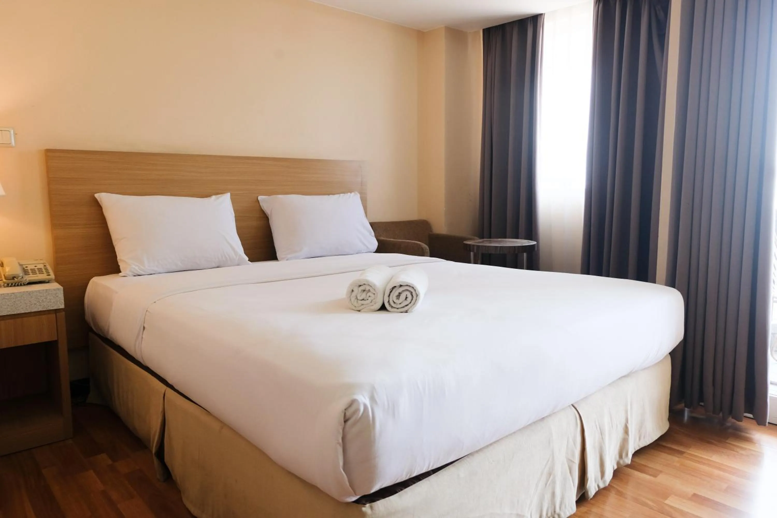 Bed in Strategic and Comfy 1BR at Braga City Walk Apartment By Travelio