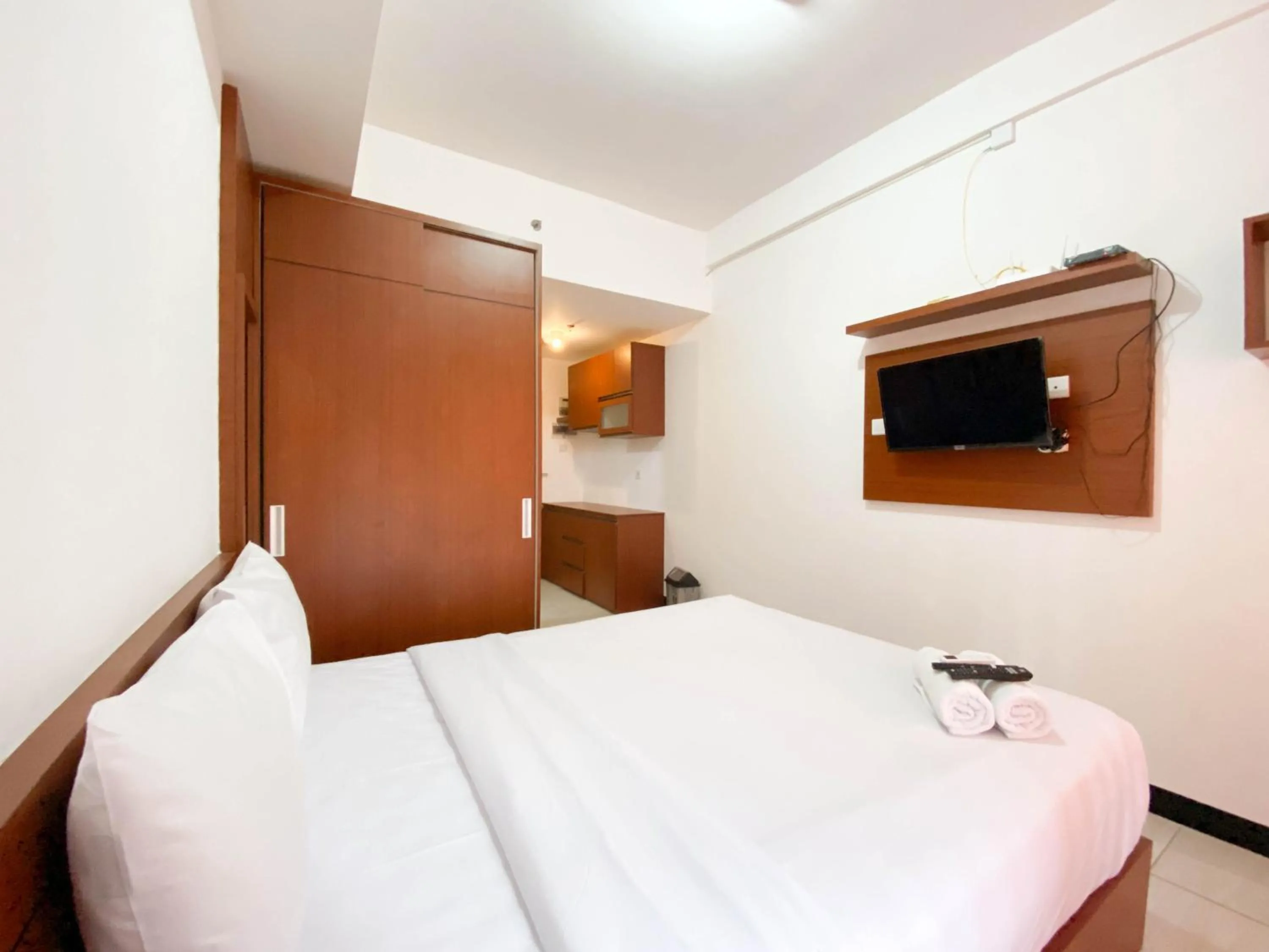 Bed in Cozy Stay Studio Cordova Edupartment Semarang Apartment By Travelio