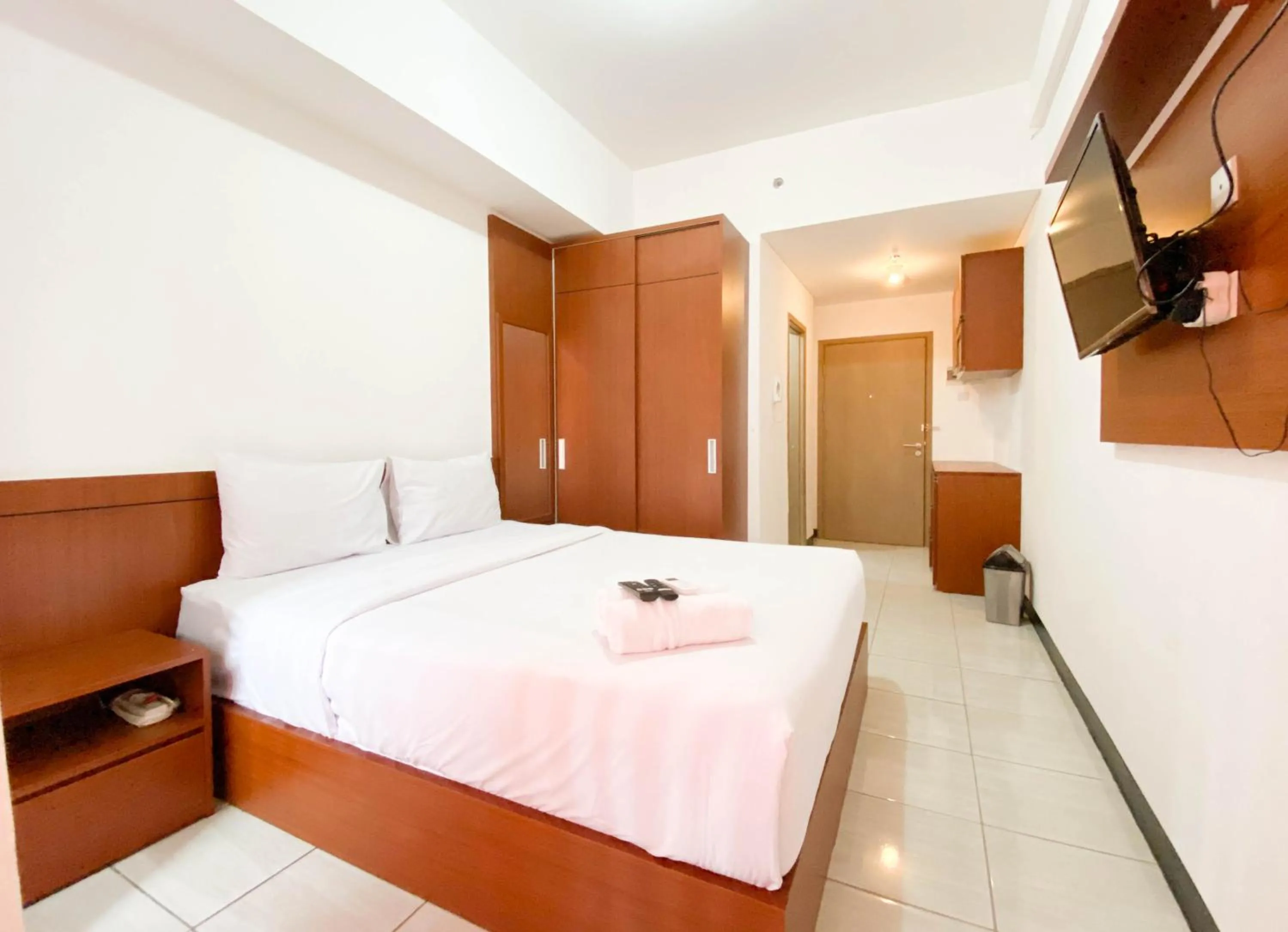 Bed in Cozy Stay Studio Cordova Edupartment Semarang Apartment By Travelio