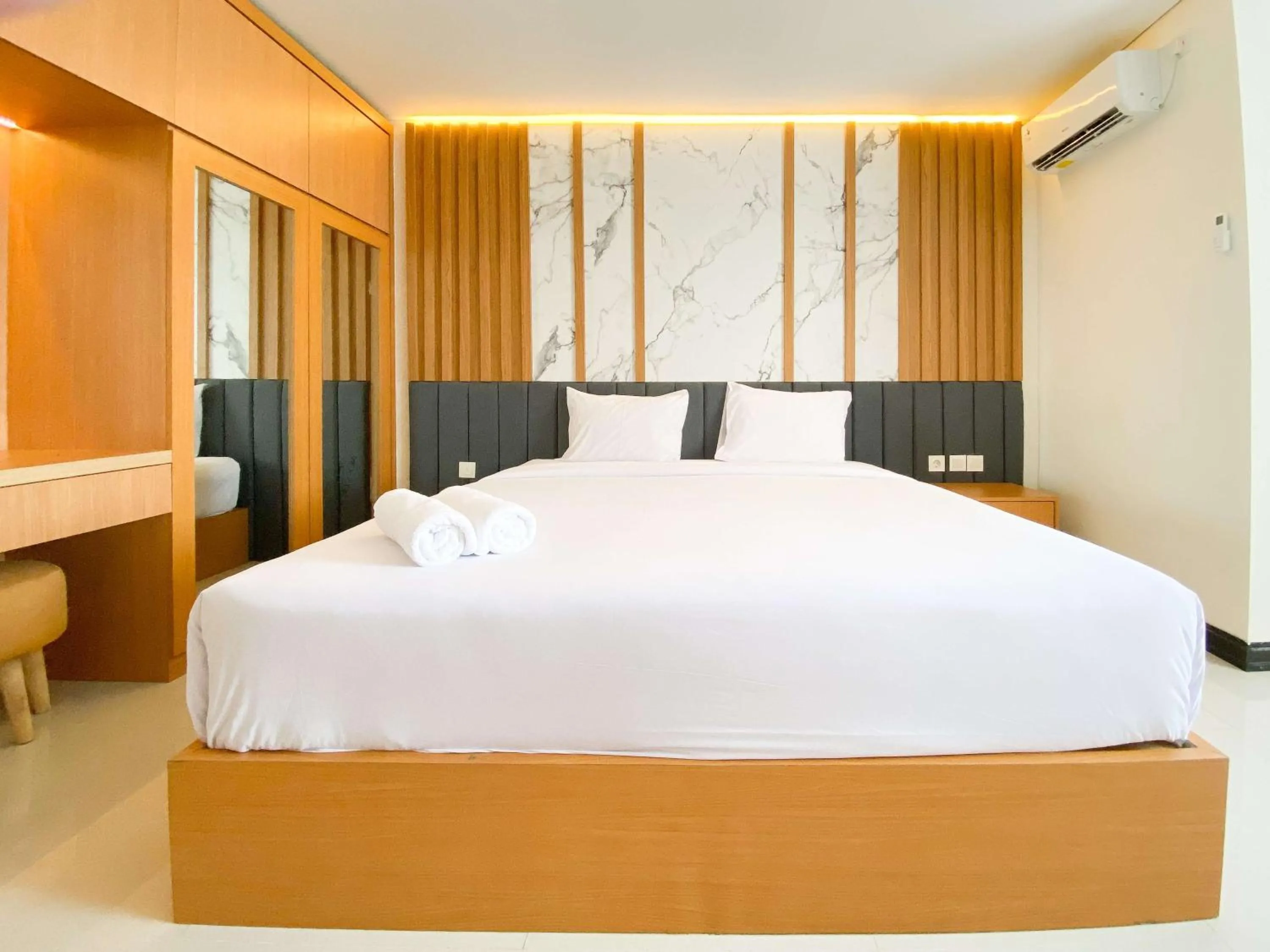 Bed in Homey and Strategic Studio (No Kitchen) at Sentraland Semarang Apartment By Travelio