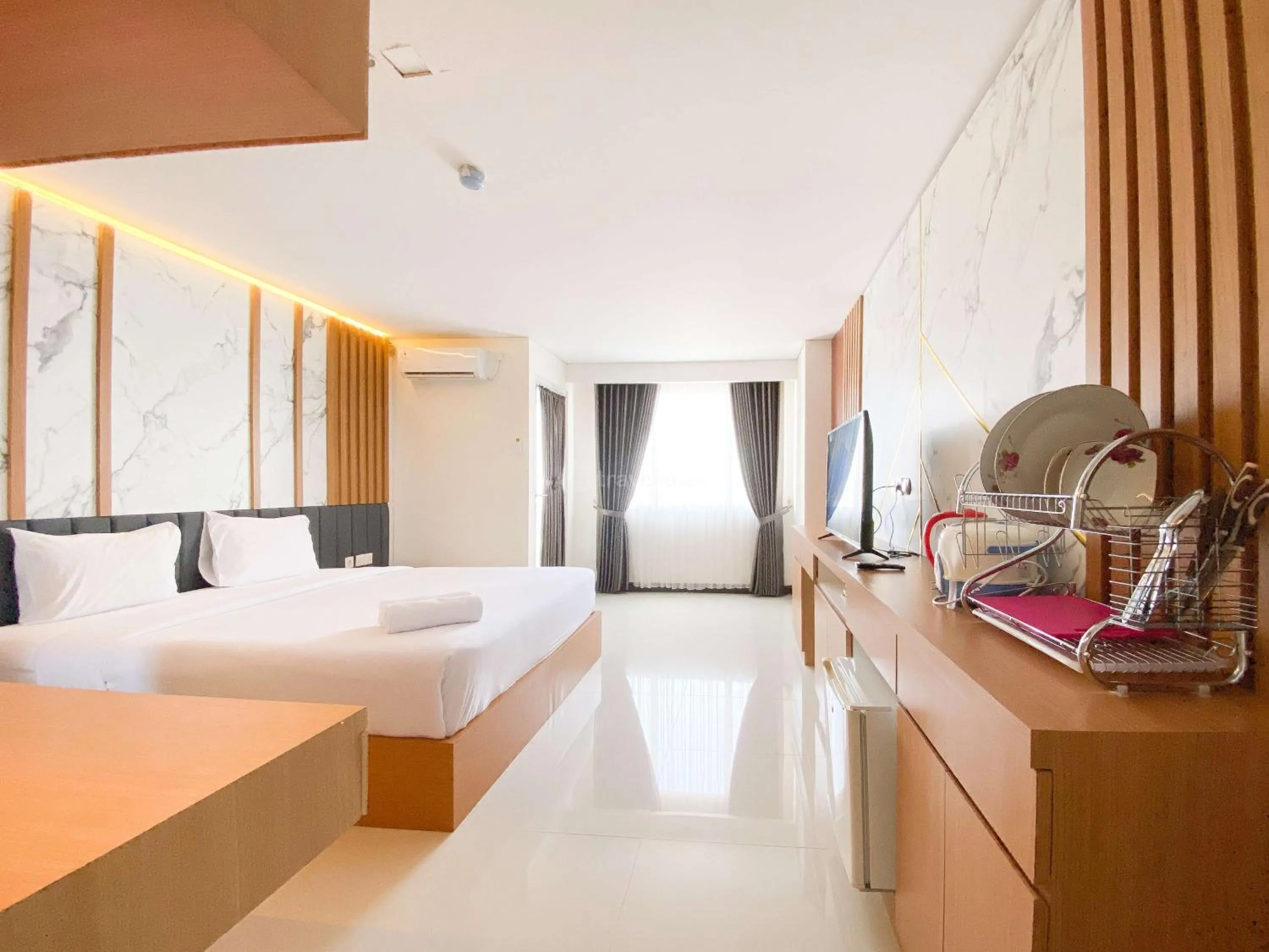 Bed in Homey and Strategic Studio (No Kitchen) at Sentraland Semarang Apartment By Travelio