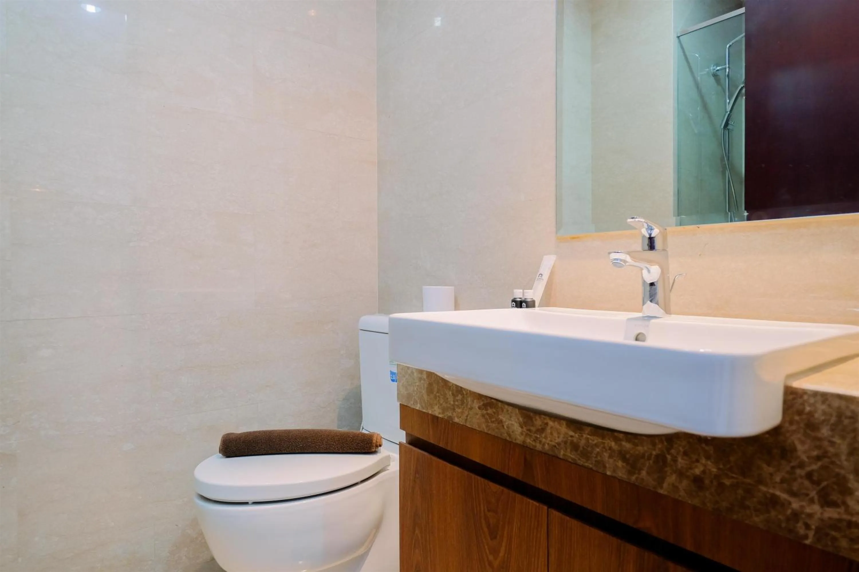 Bathroom in Comfort and Modern Look Studio Menteng Park Apartment By Travelio
