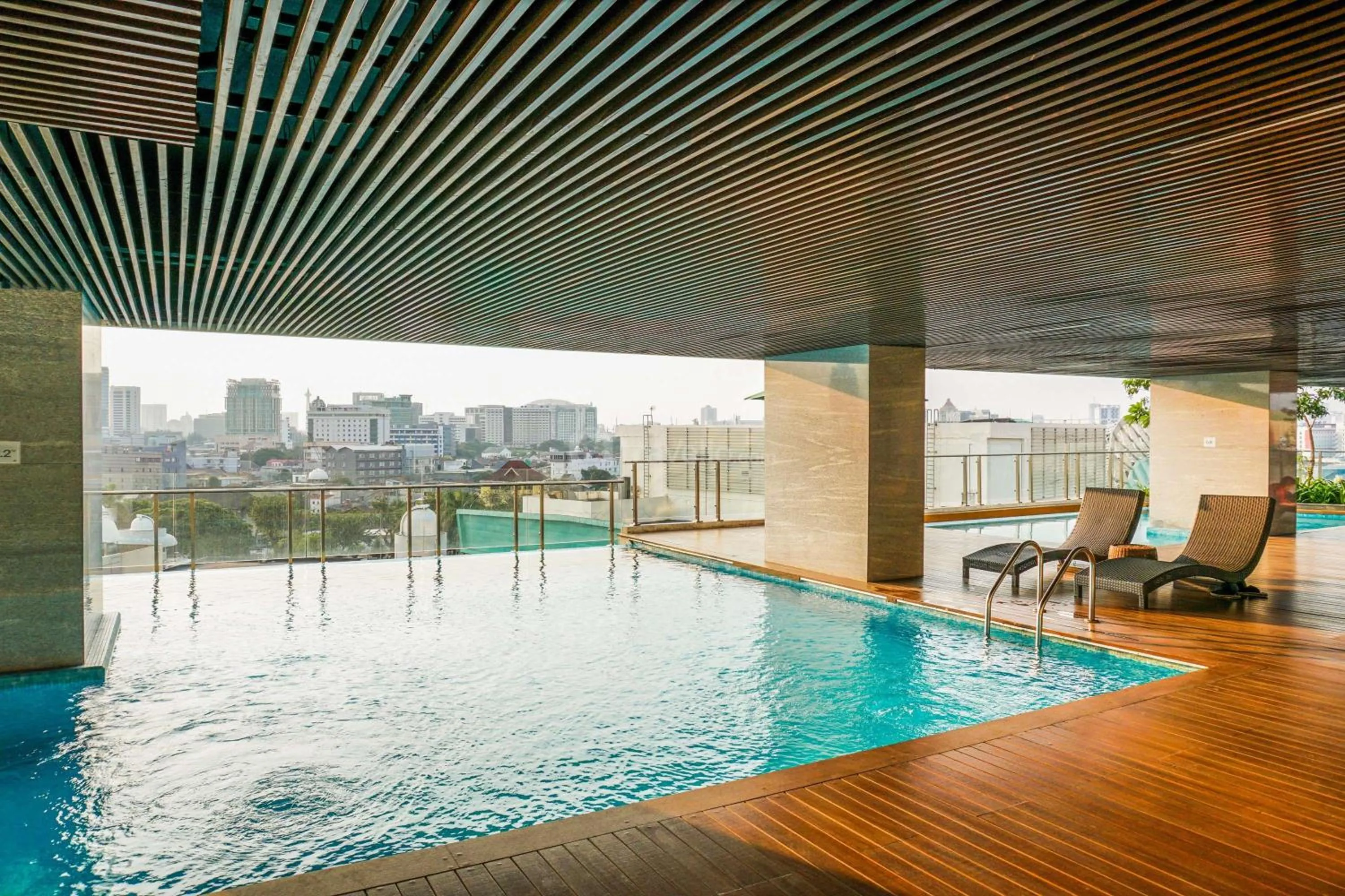 Swimming pool in Comfort and Modern Look Studio Menteng Park Apartment By Travelio